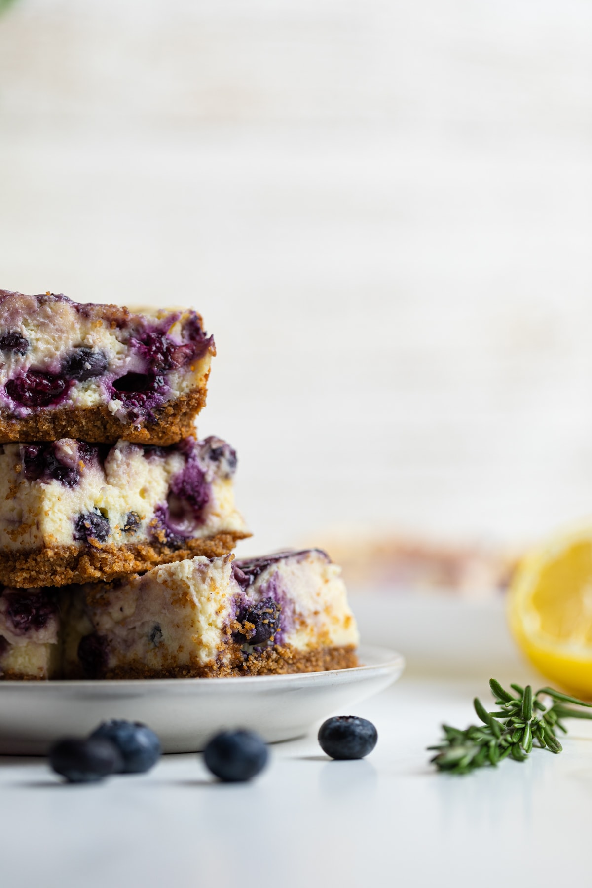 White plate of Lemon Blueberry Cheesecake Bars.