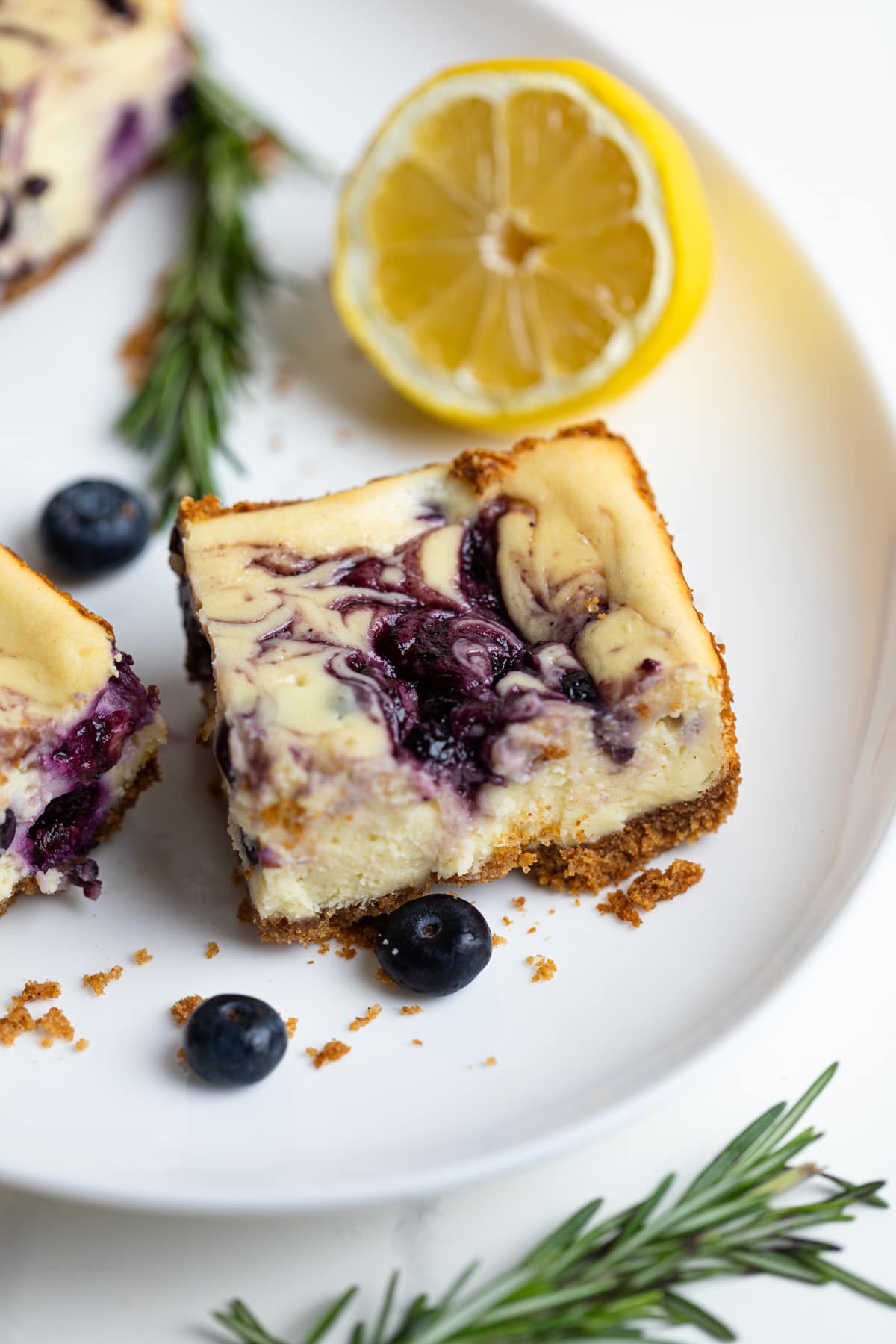 Lemon Blueberry Cheesecake Bars with a half lemon slice.