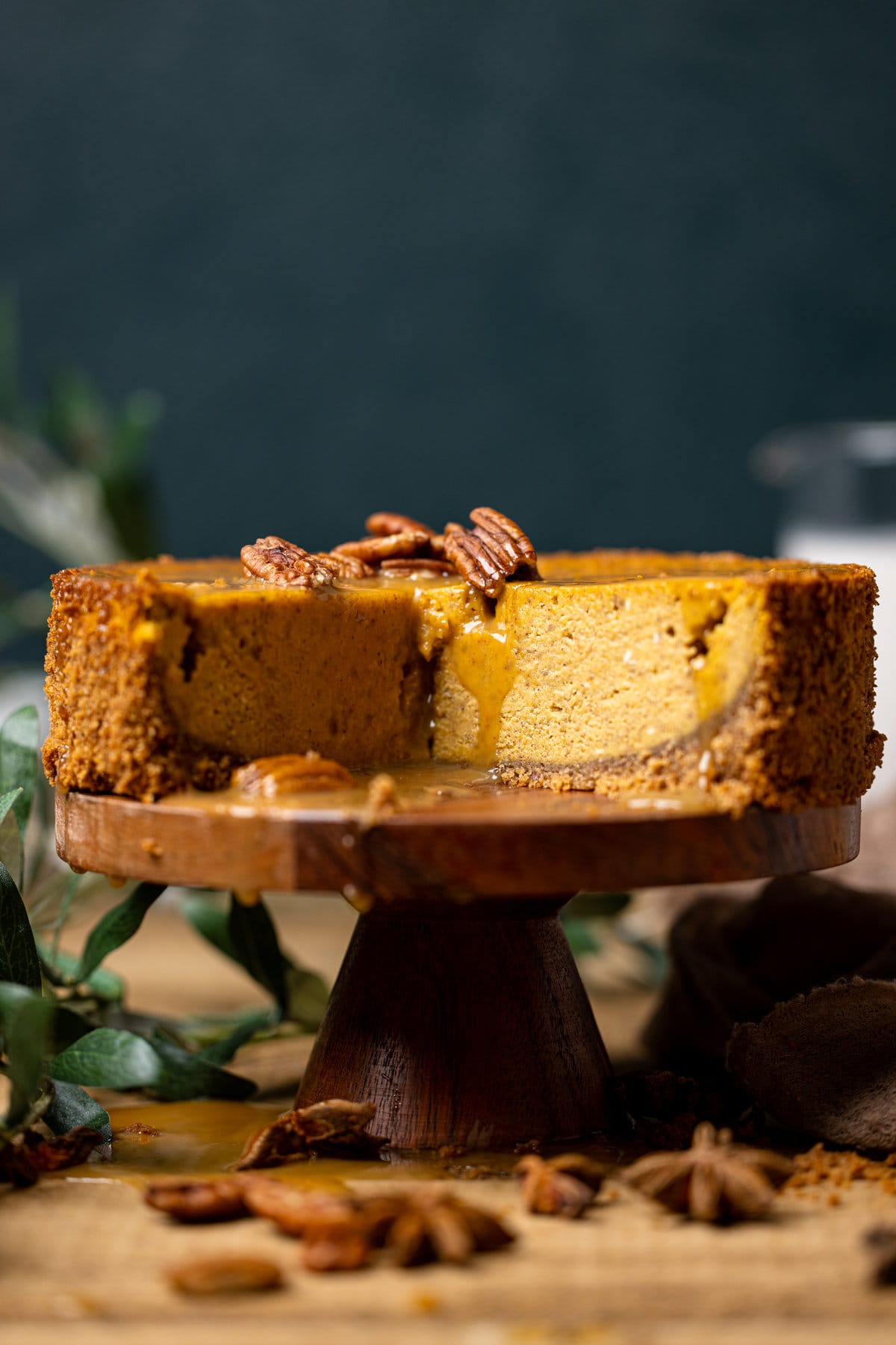 Caramel Pumpkin Cheesecake with a Pecan Crust missing a slice