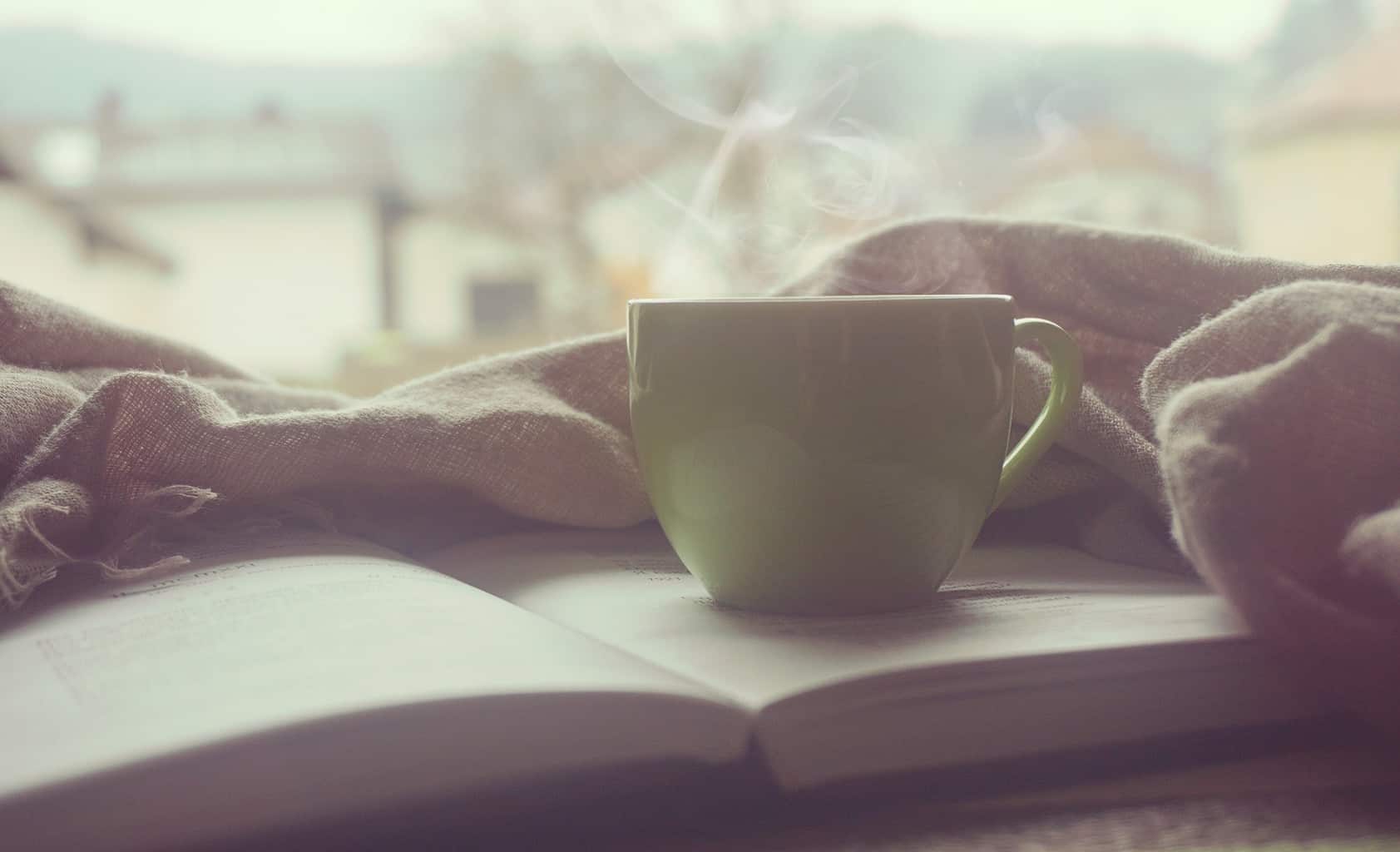 Steaming mug sitting on a book.