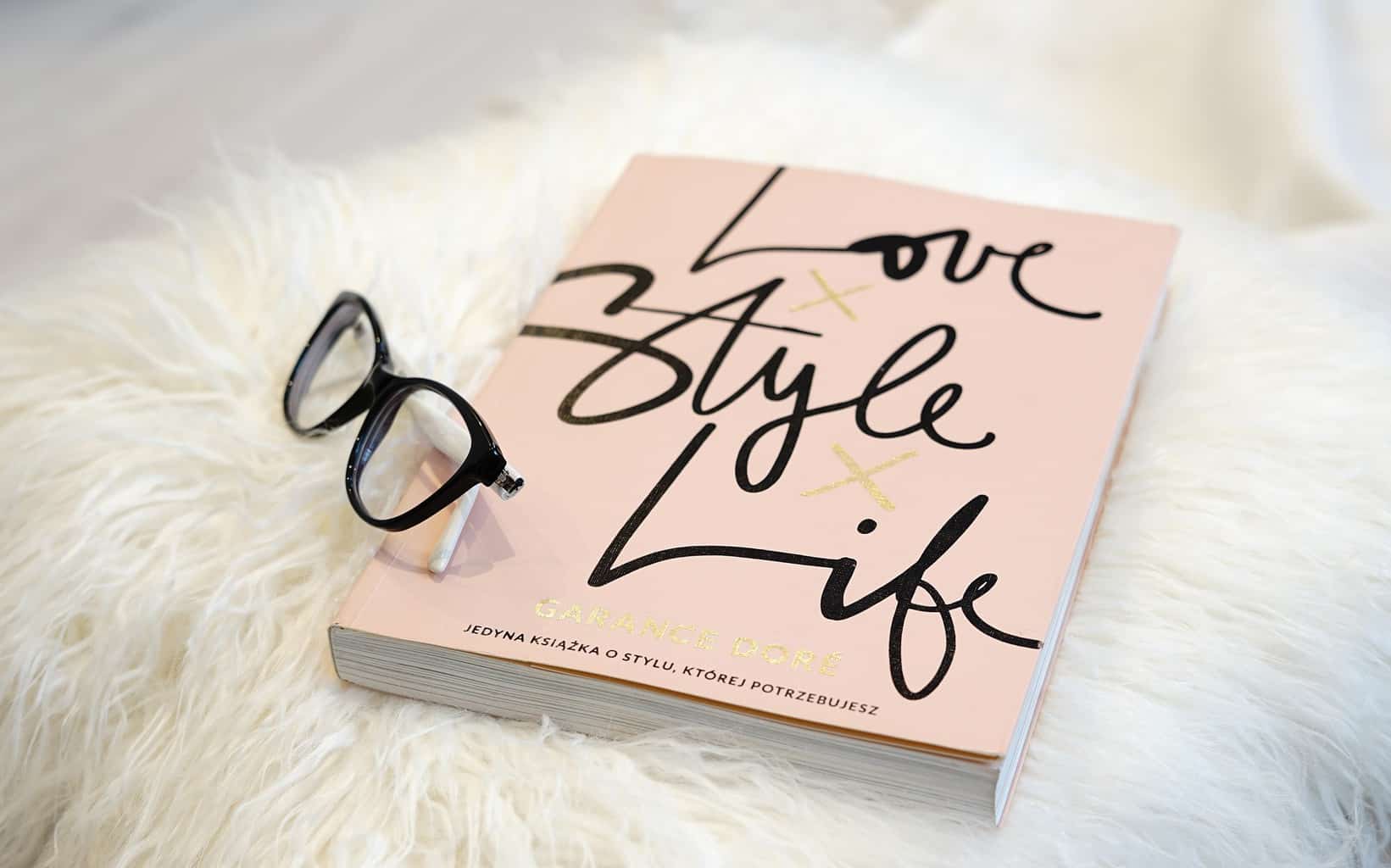 Glasses sitting on a copy of the book \"Love Style Life.\"