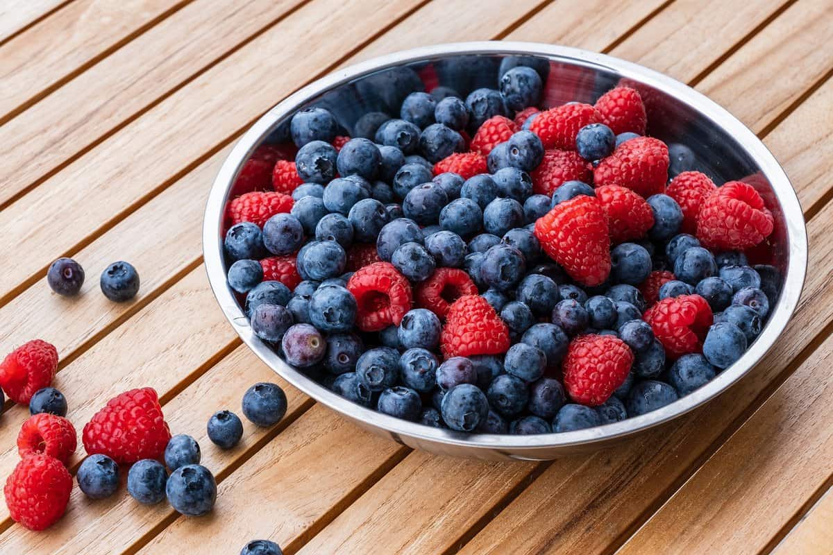 Large bowl of blueberries and raspberries.