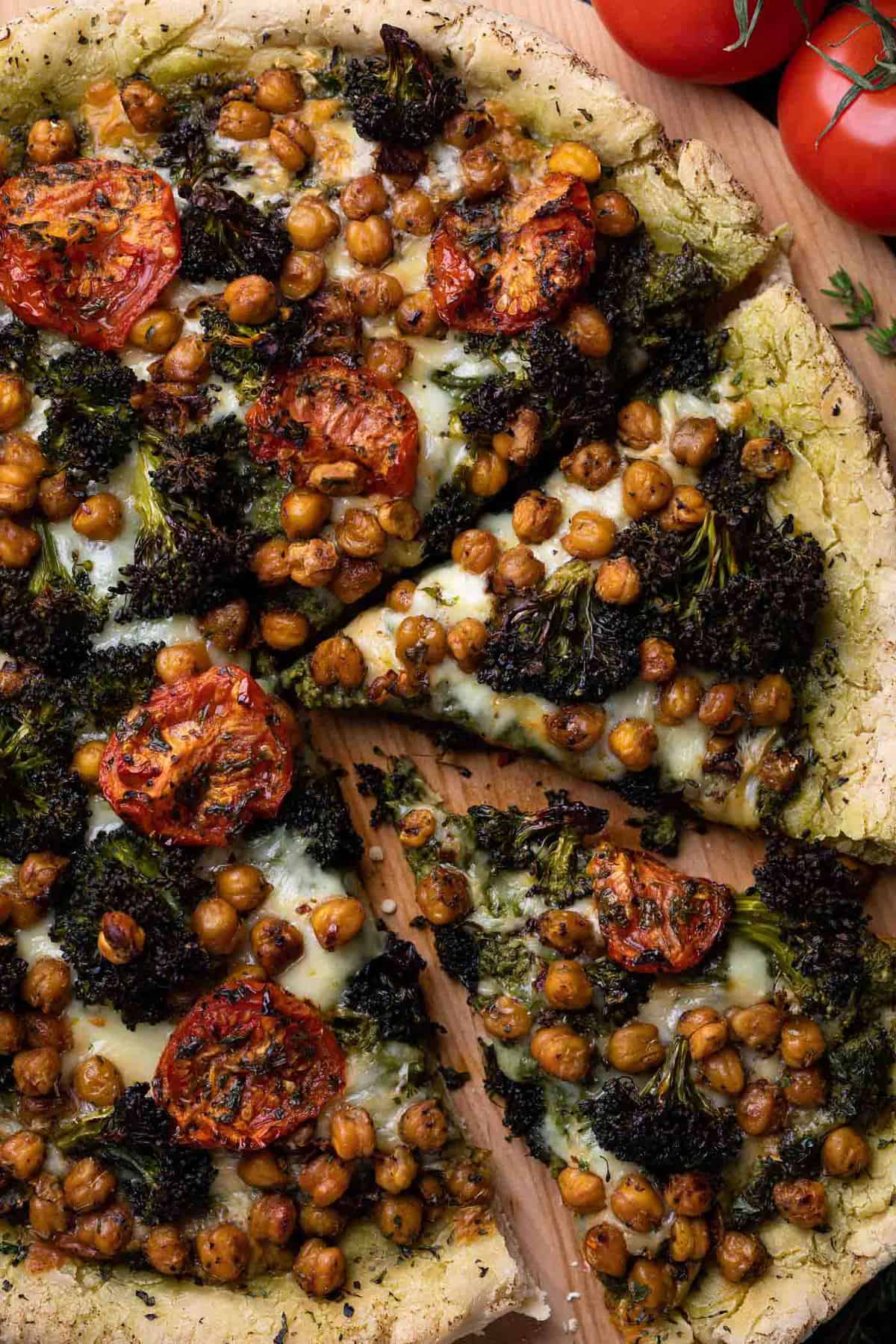 Partially-sliced Chickpea and Veggie Gluten-Free Pesto Pizza