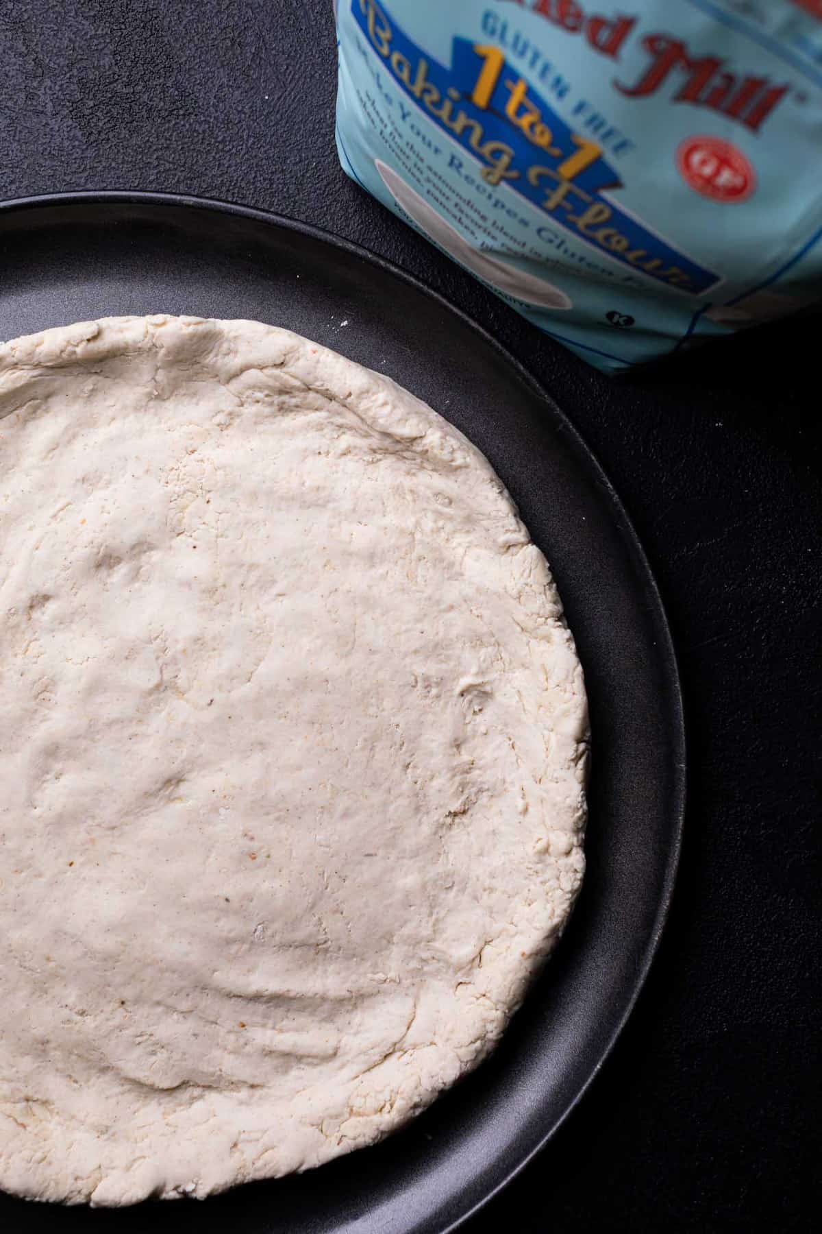 Gluten-Free Pizza dough on a pan.