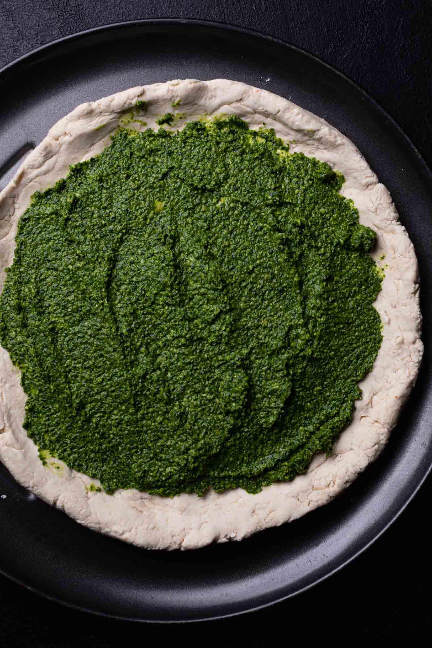 Gluten-Free Pizza dough spread with pesto.