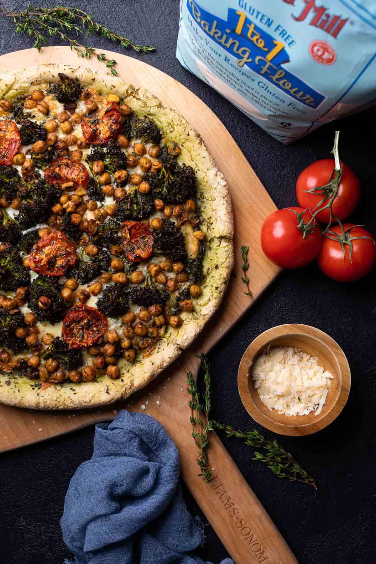 Chickpea and Veggie Gluten-Free Pesto Pizza with a bag of Bob\'s Red Mill gluten-free flour.