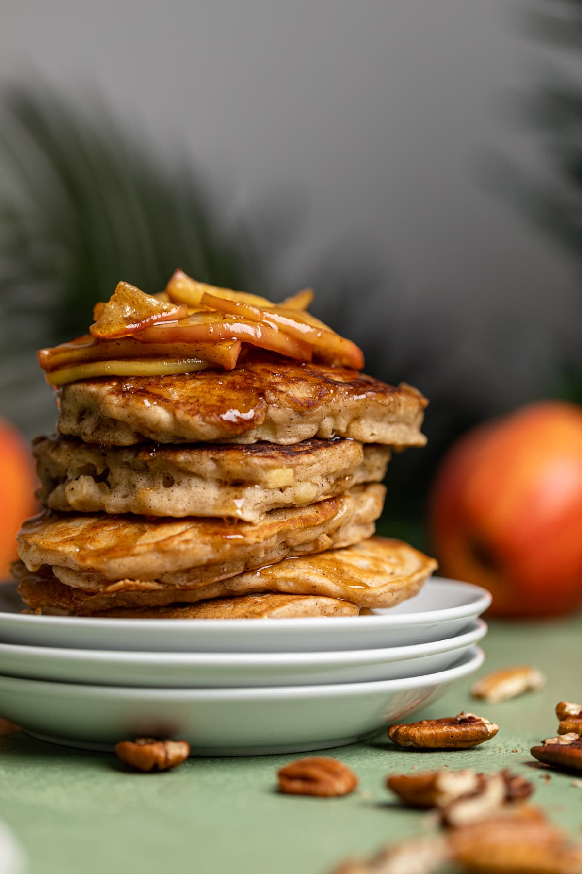 Stack of Vegan Apple Cinnamon Pancakes on three small, stacked plates