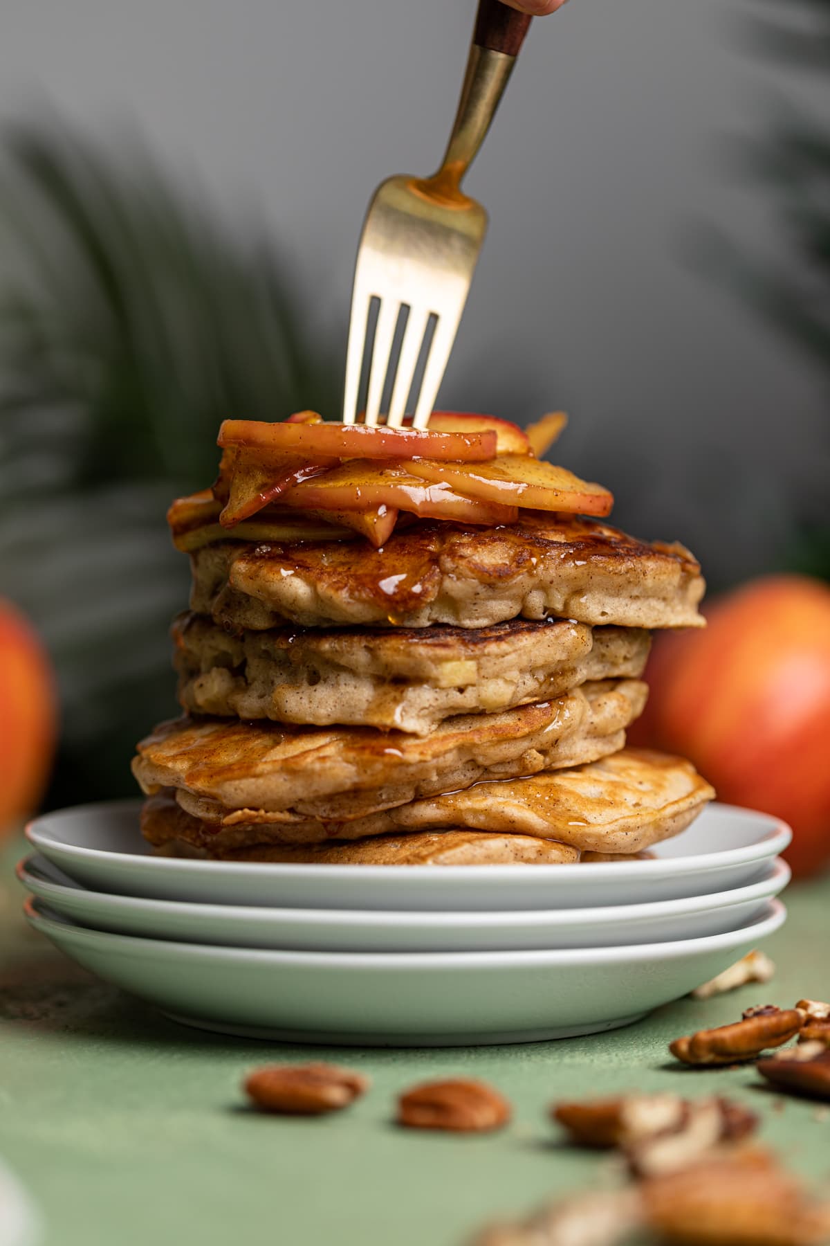 Fork in a stack of Vegan Apple Cinnamon Pancakes