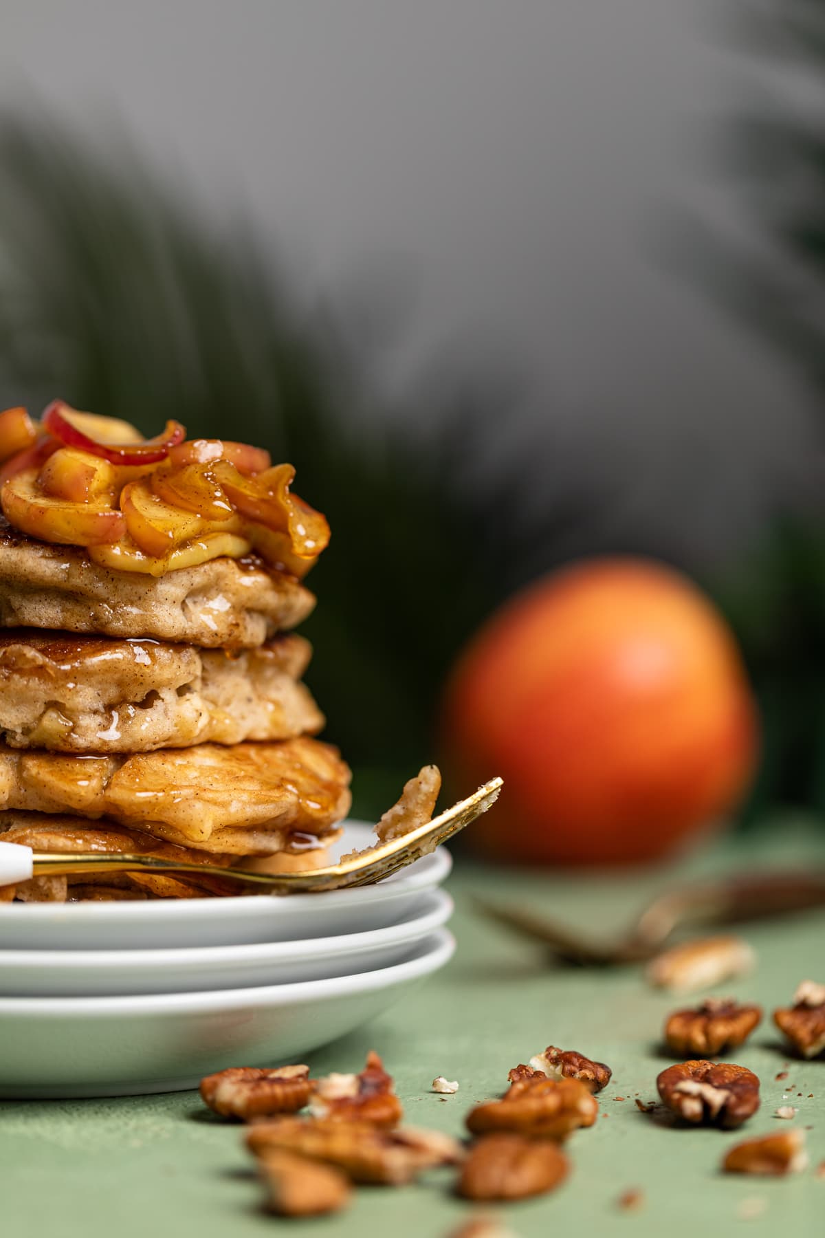 Stack of Vegan Apple Cinnamon Pancakes topped with caramelized apples
