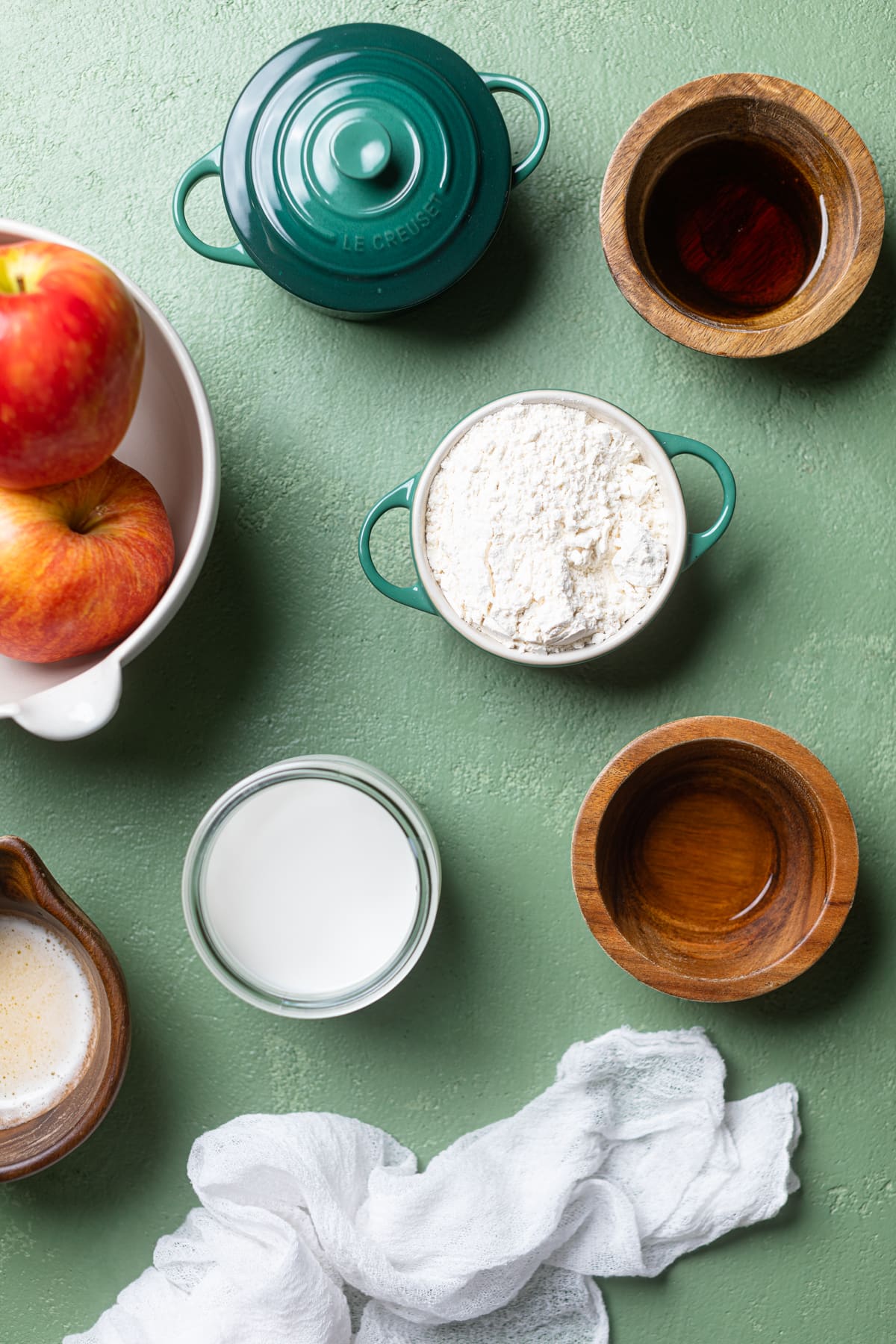 Ingredients for Vegan Apple Cinnamon Pancakes including apples, flour, and almond milk