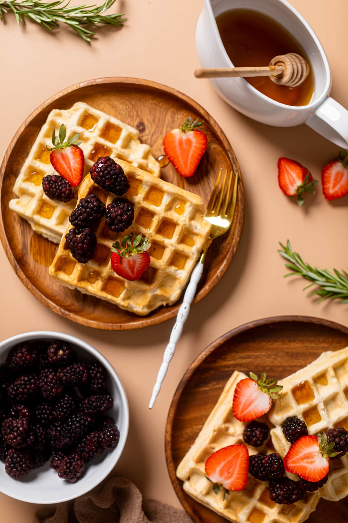 Fork on a wooden plate of Fluffy Cinnamon Vegan Belgian Waffles.