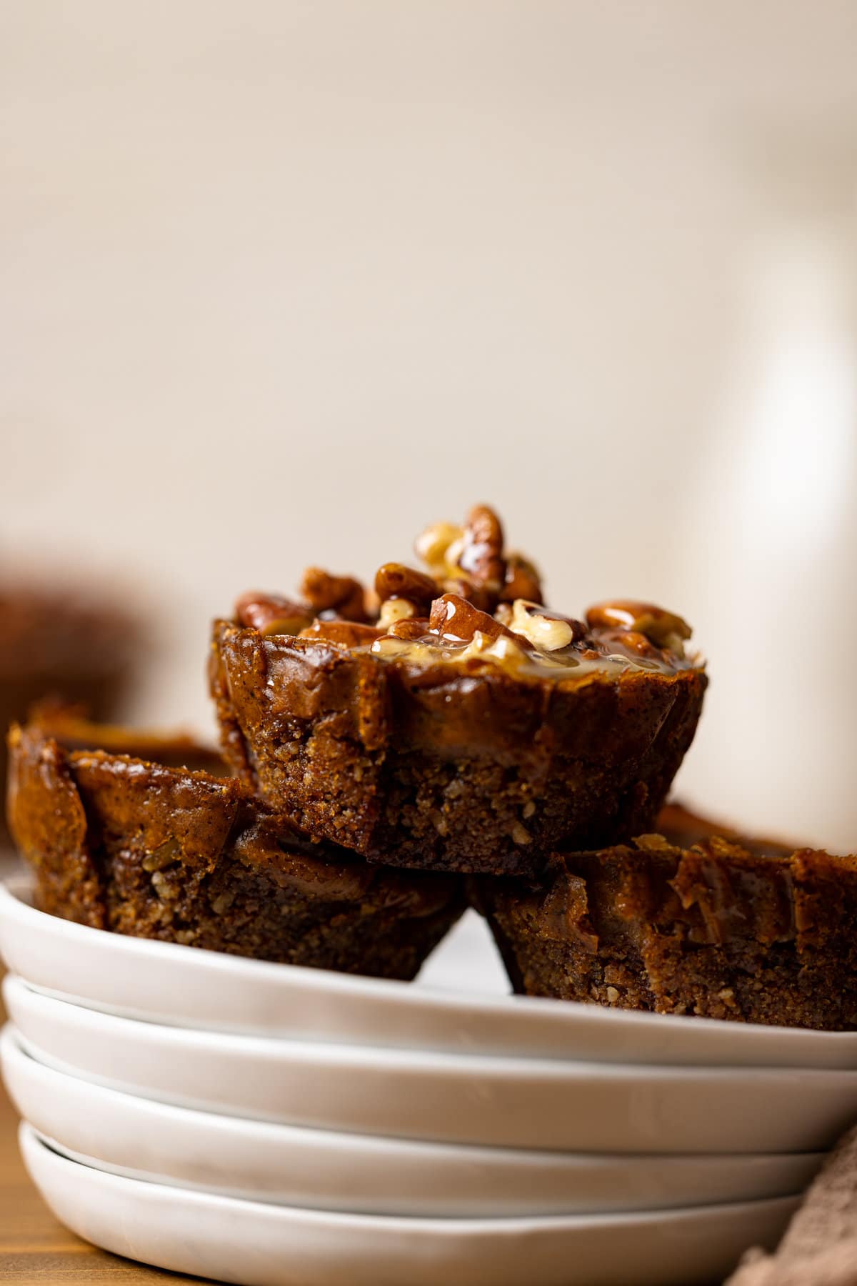 Three Mini Sweet Potato Pecan Pies on small plates.