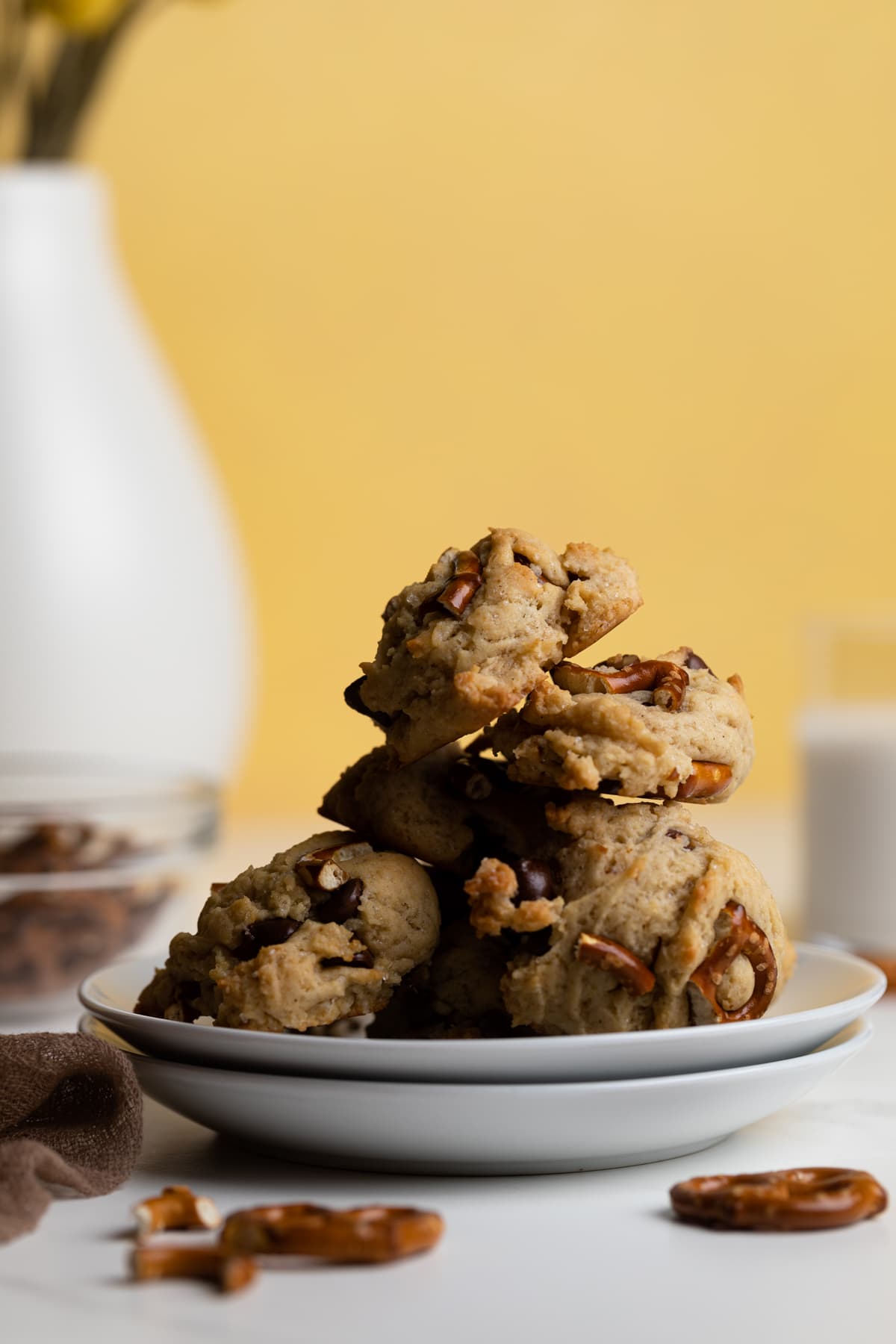 Tall pile of Chunky Vegan Chocolate Chip and Pretzel Cookies.