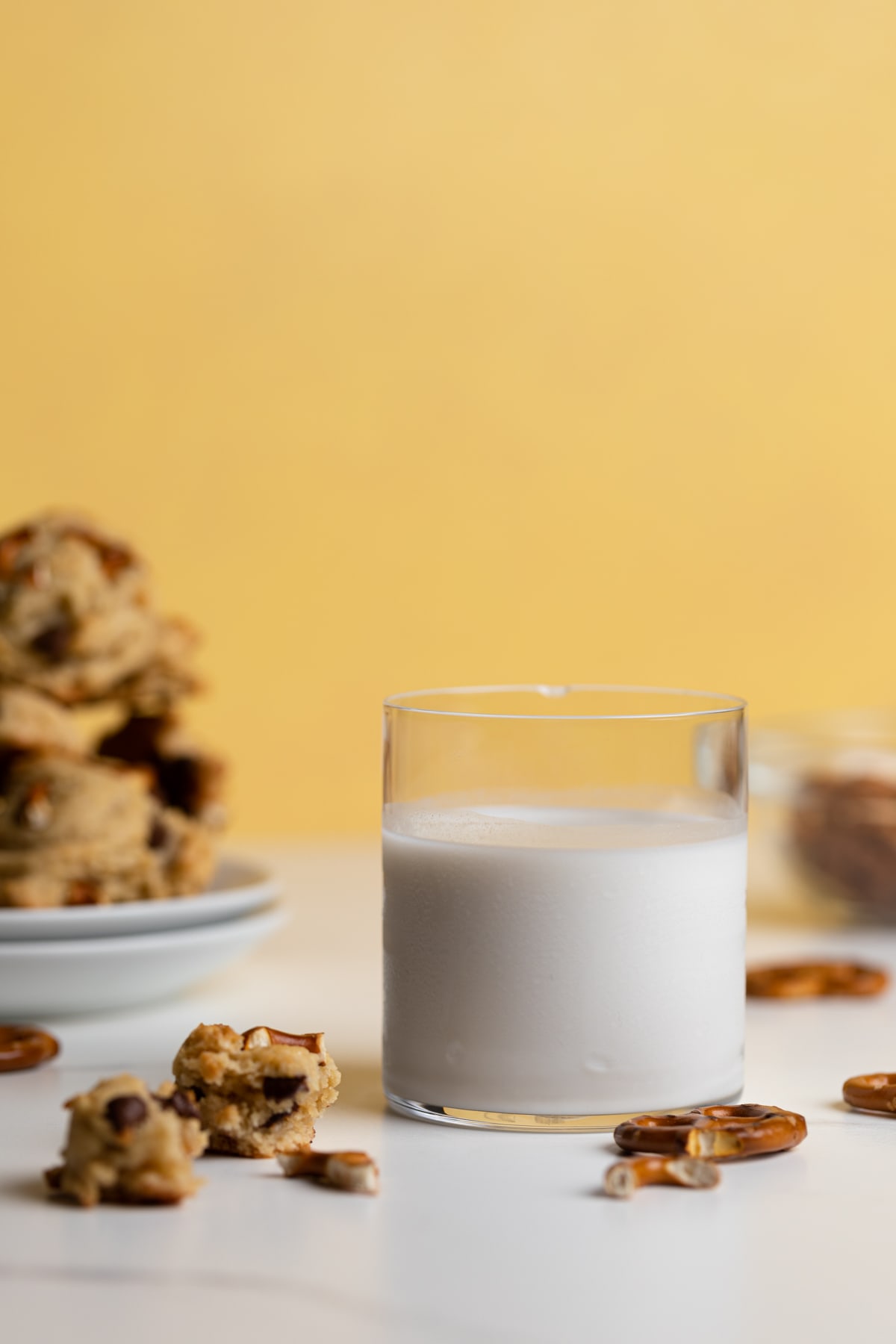 Chunky Vegan Chocolate Chip and Pretzel Cookies with a glass of milk.