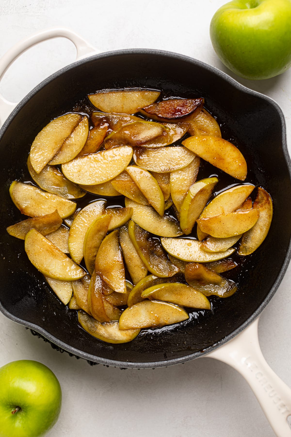 Apple slices caramelizing in a pan