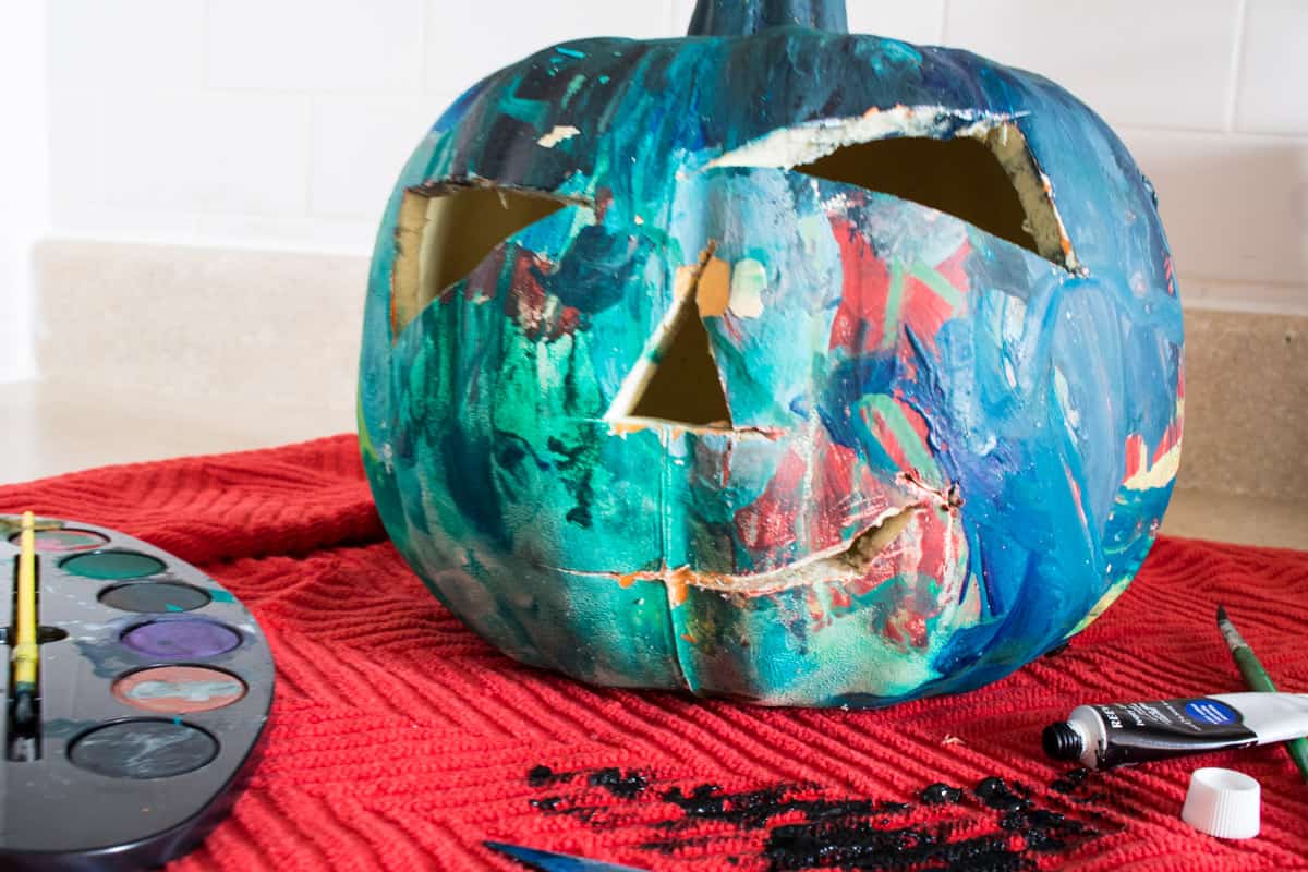 Painted jack-o-lantern on a red towel.