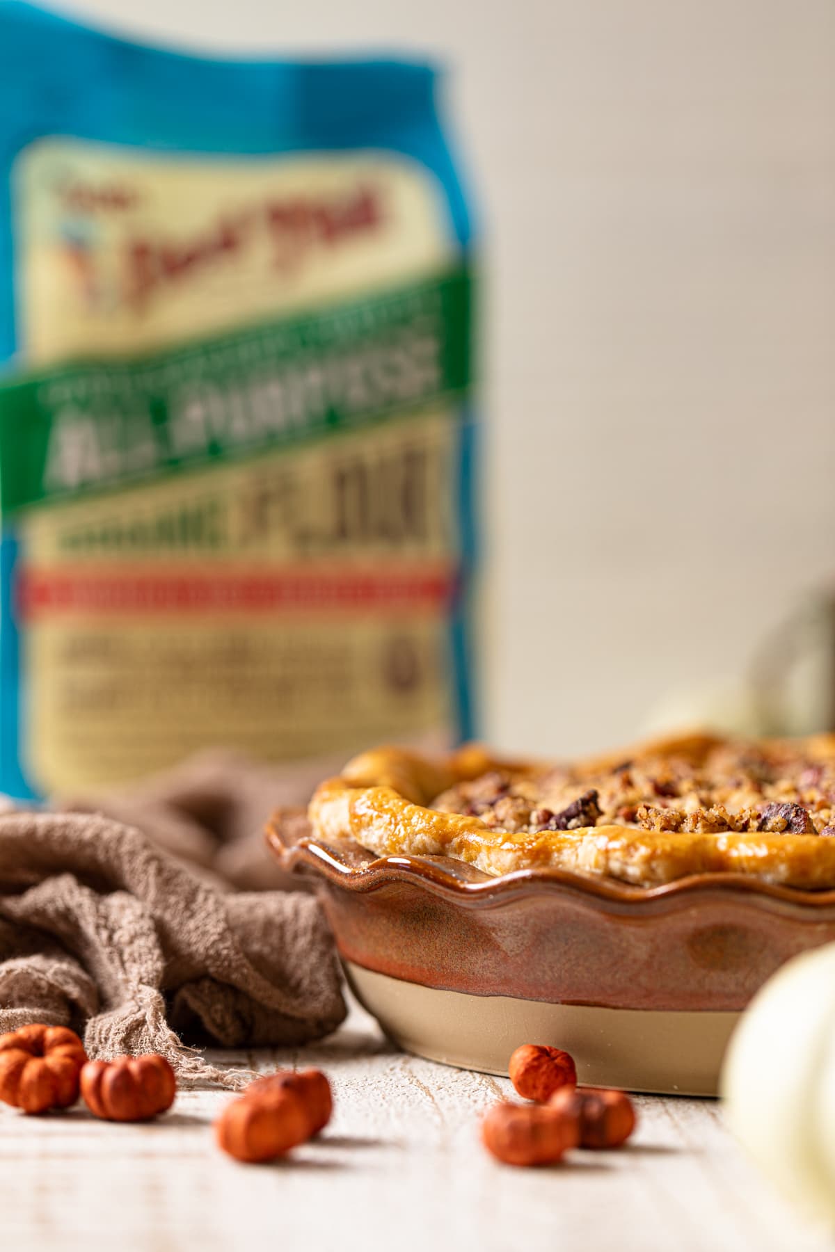 Vegan Maple Pumpkin Pie in front of a bag of Bob\'s Red Mill organic flour