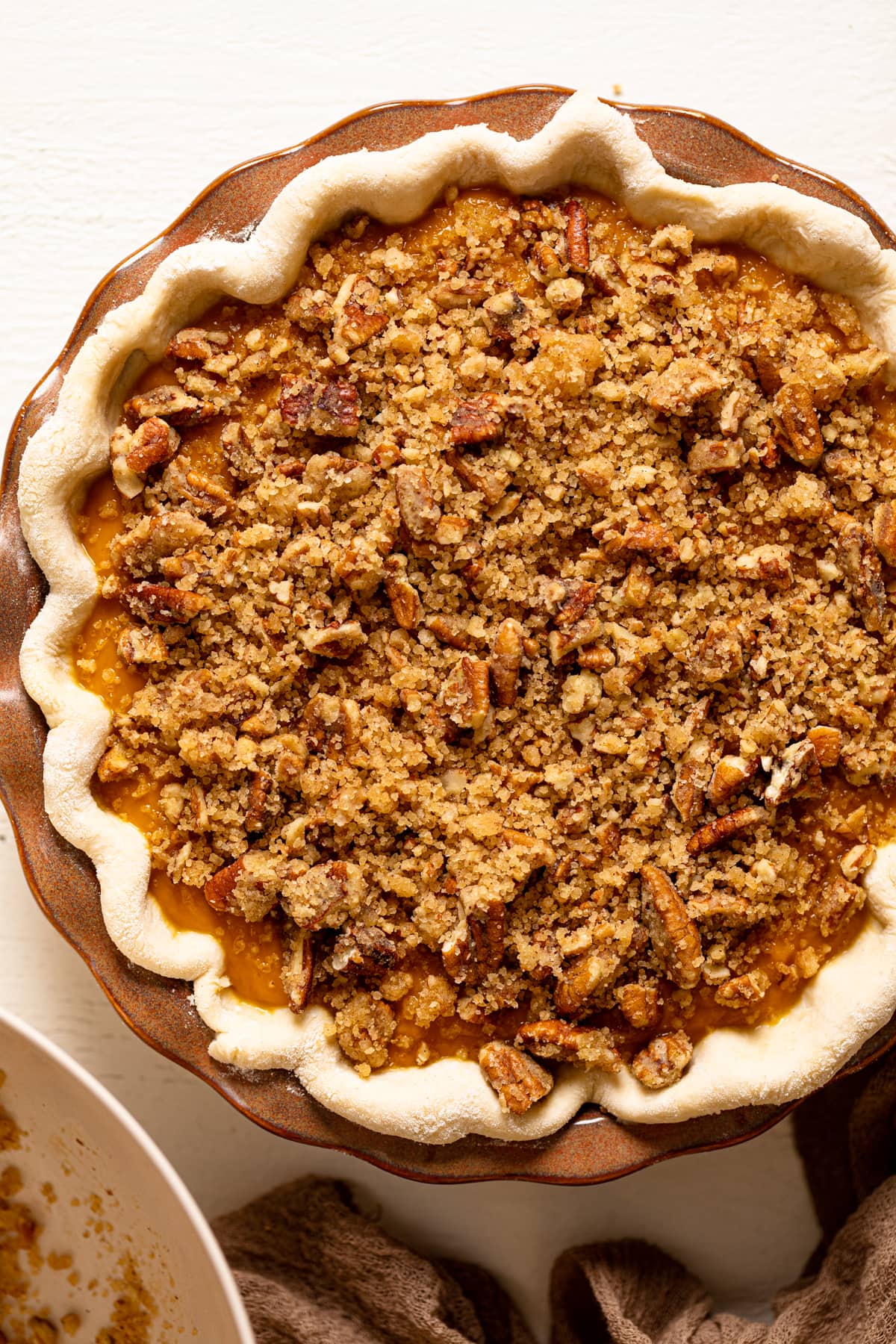 Uncooked Vegan Maple Pumpkin Pie topped with crumble topping