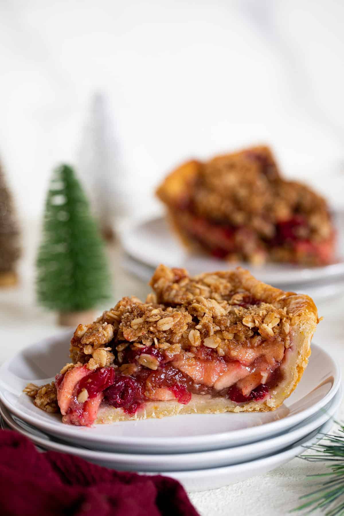 Slice of Vegan Apple Cranberry Crumble Pie on two small, stacked plates