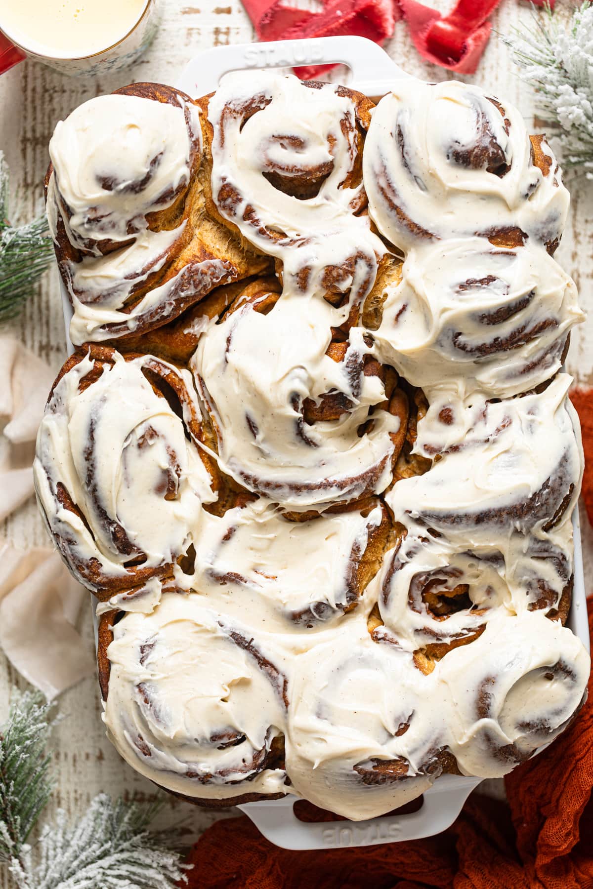 Gingerbread Cinnamon Rolls with Maple Cream Cheese Frosting in a baking pan