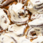 Closeup of Gingerbread Cinnamon Rolls with Maple Cream Cheese Frosting