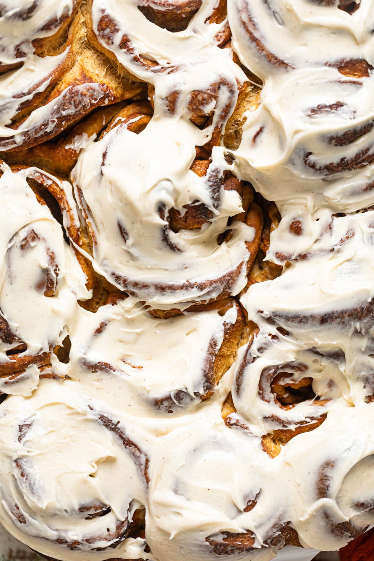 Closeup of Gingerbread Cinnamon Rolls with Maple Cream Cheese Frosting 