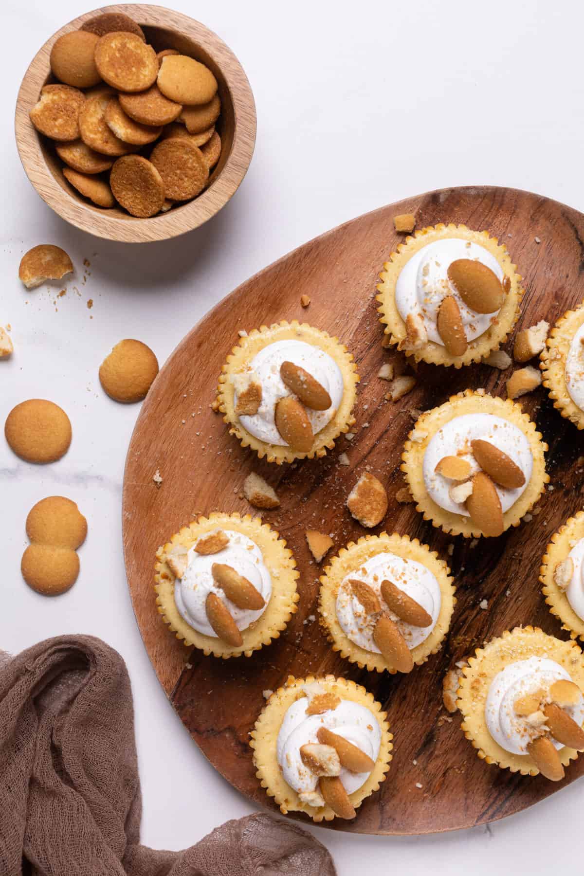 Wooden board of Banana Pudding Cheesecake Bites.