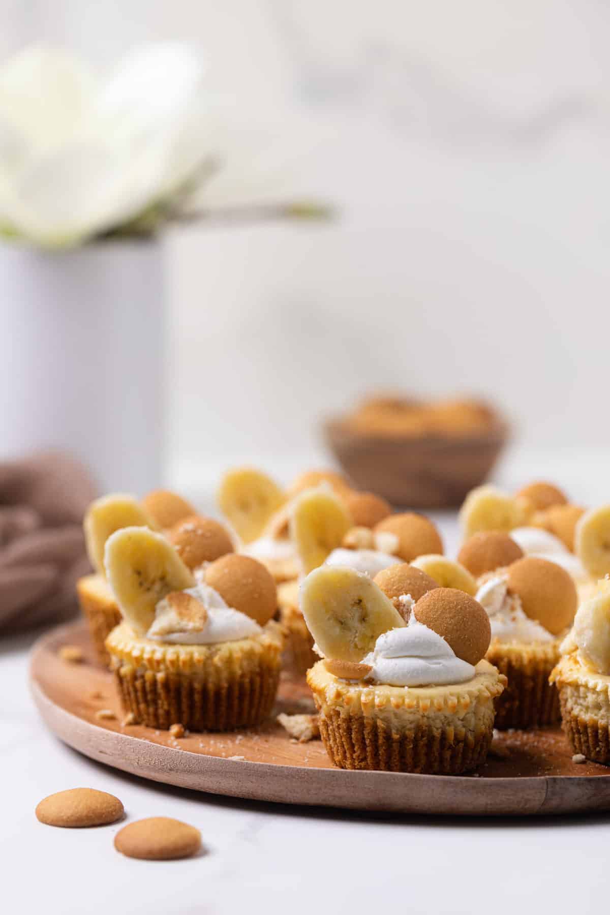 Banana Pudding Cheesecake Bites on a wooden board.