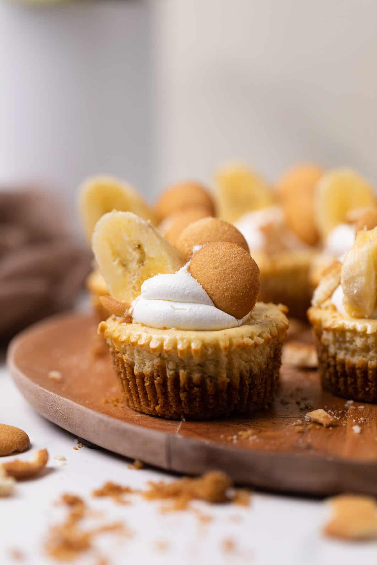 Banana Pudding Cheesecake Bites on a wooden board.