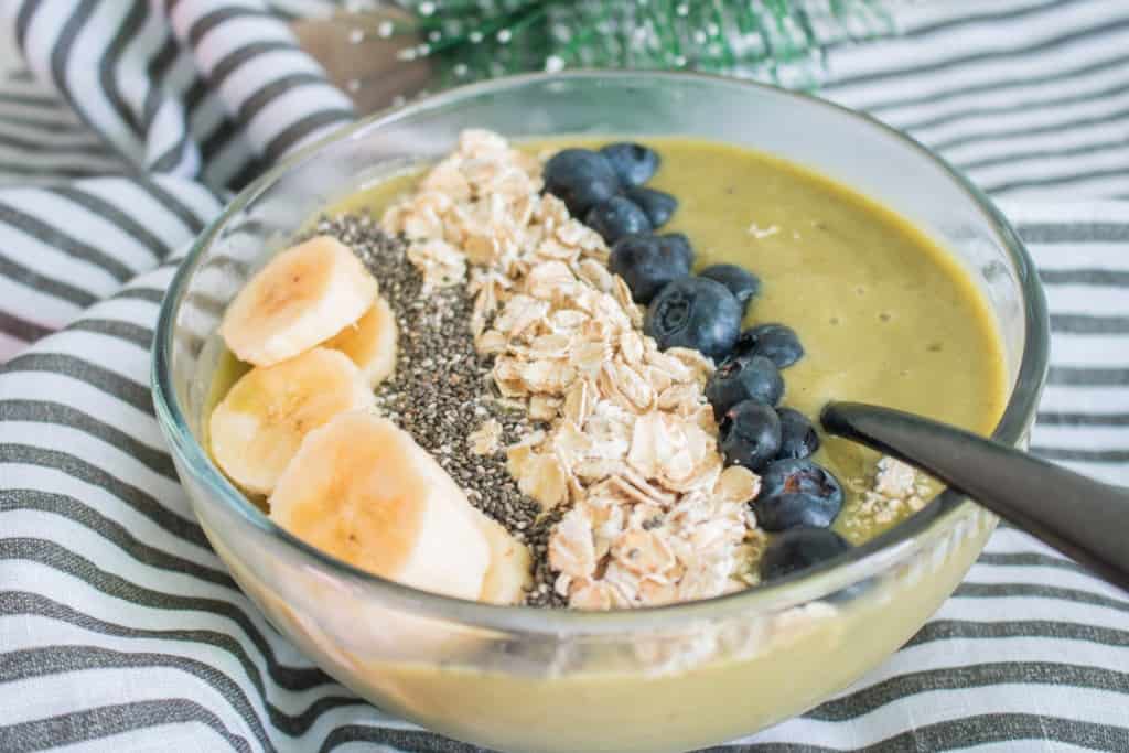 Smoothie bowl topped with bananas, blueberries, and other toppings.