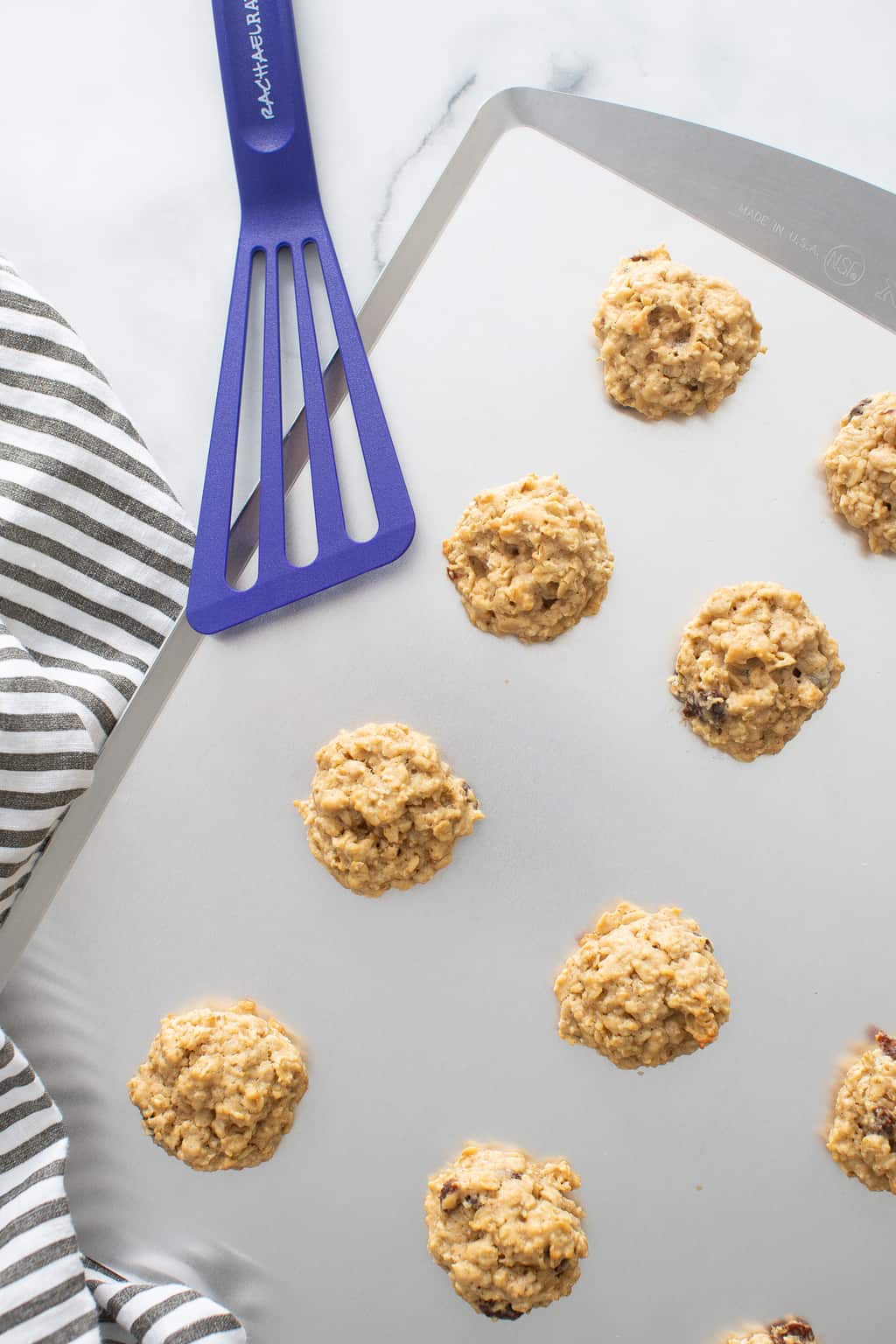 Chewy Apple Oatmeal Raisin Breakfast Cookies on a baking sheet.