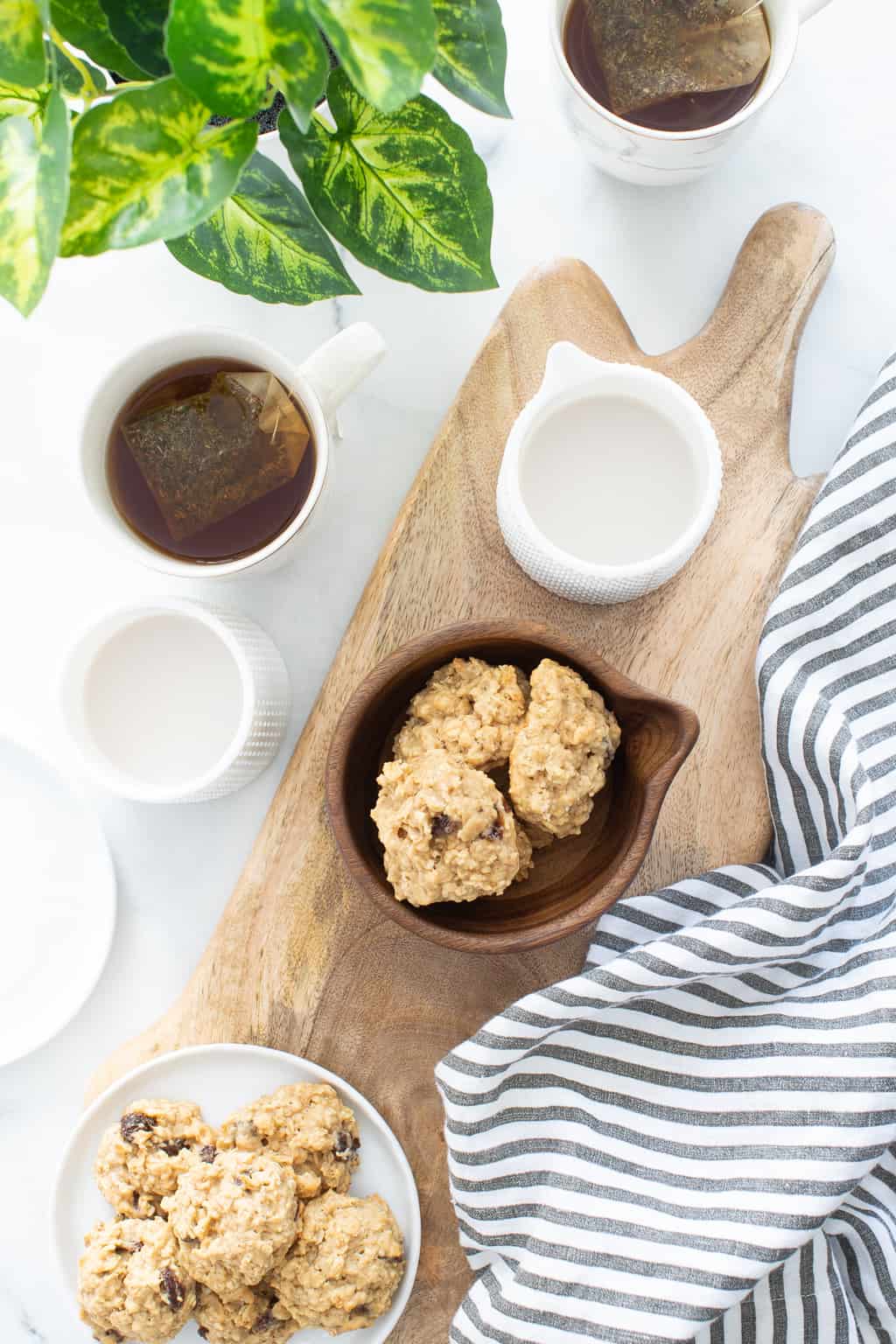 Chewy Apple Oatmeal Raisin Breakfast Cookies with mugs of tea.