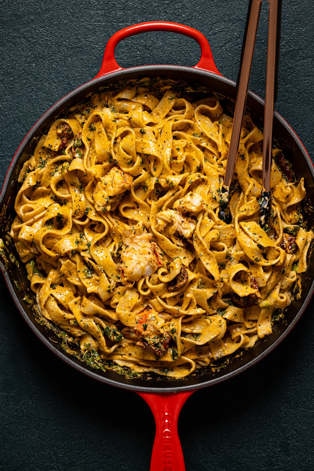 Creamy Tuscan Lobster Pasta being tossed in a pan