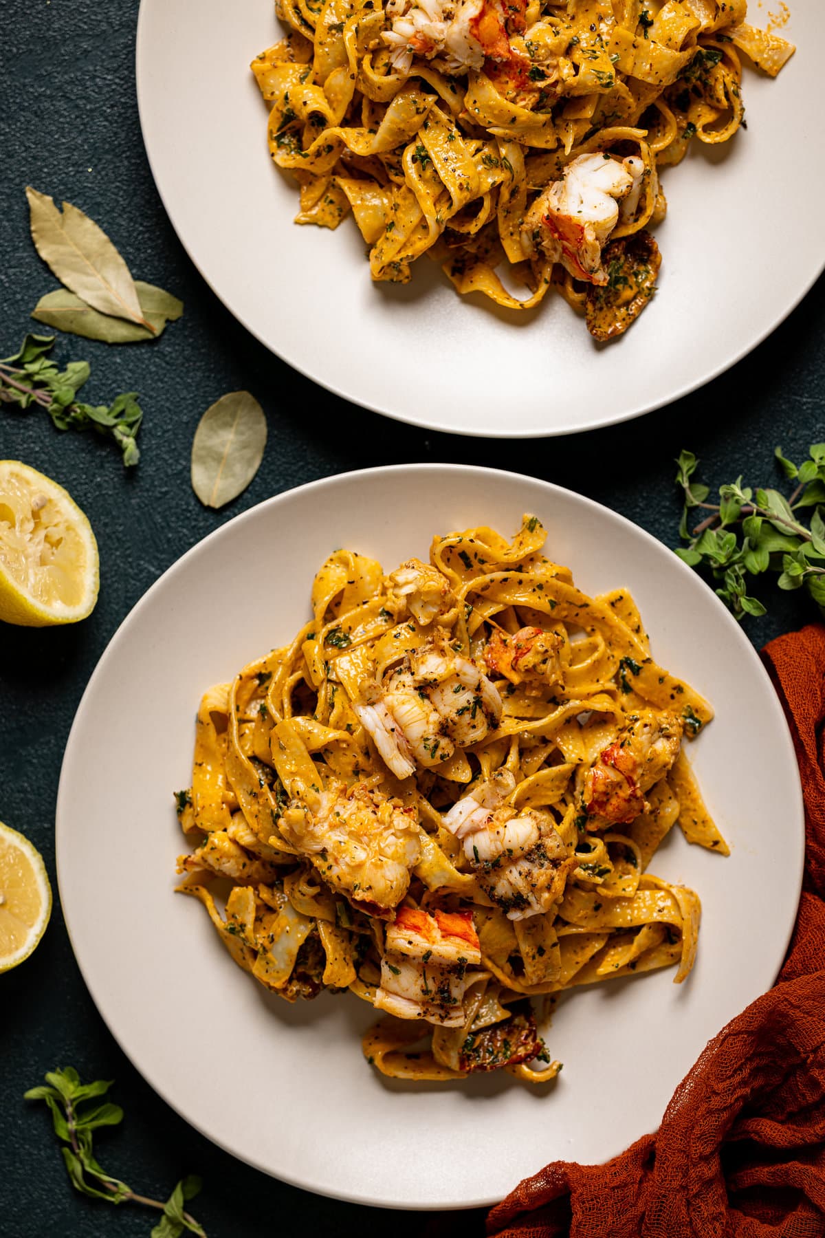 Overhead shot of two plates of Creamy Tuscan Lobster Pasta