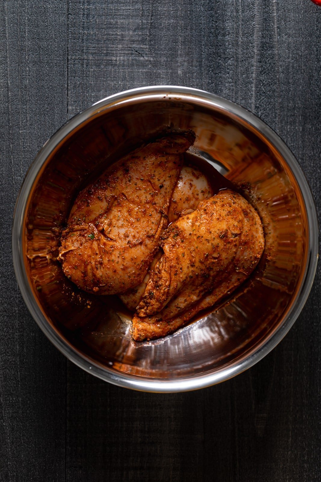 Bowl of seasoned chicken breasts for this easy weeknight dinner.
