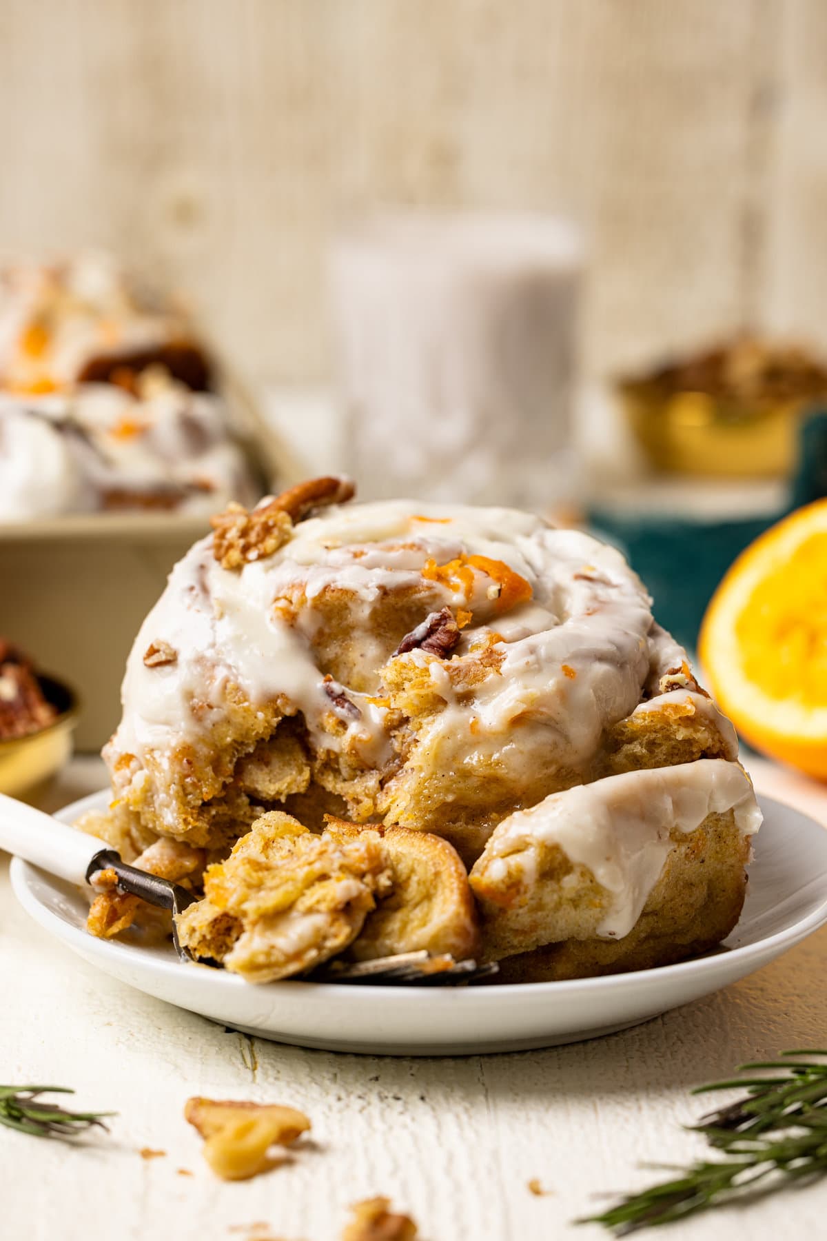 Southern-Style Carrot Cake Cinnamon Roll on a plate with a fork