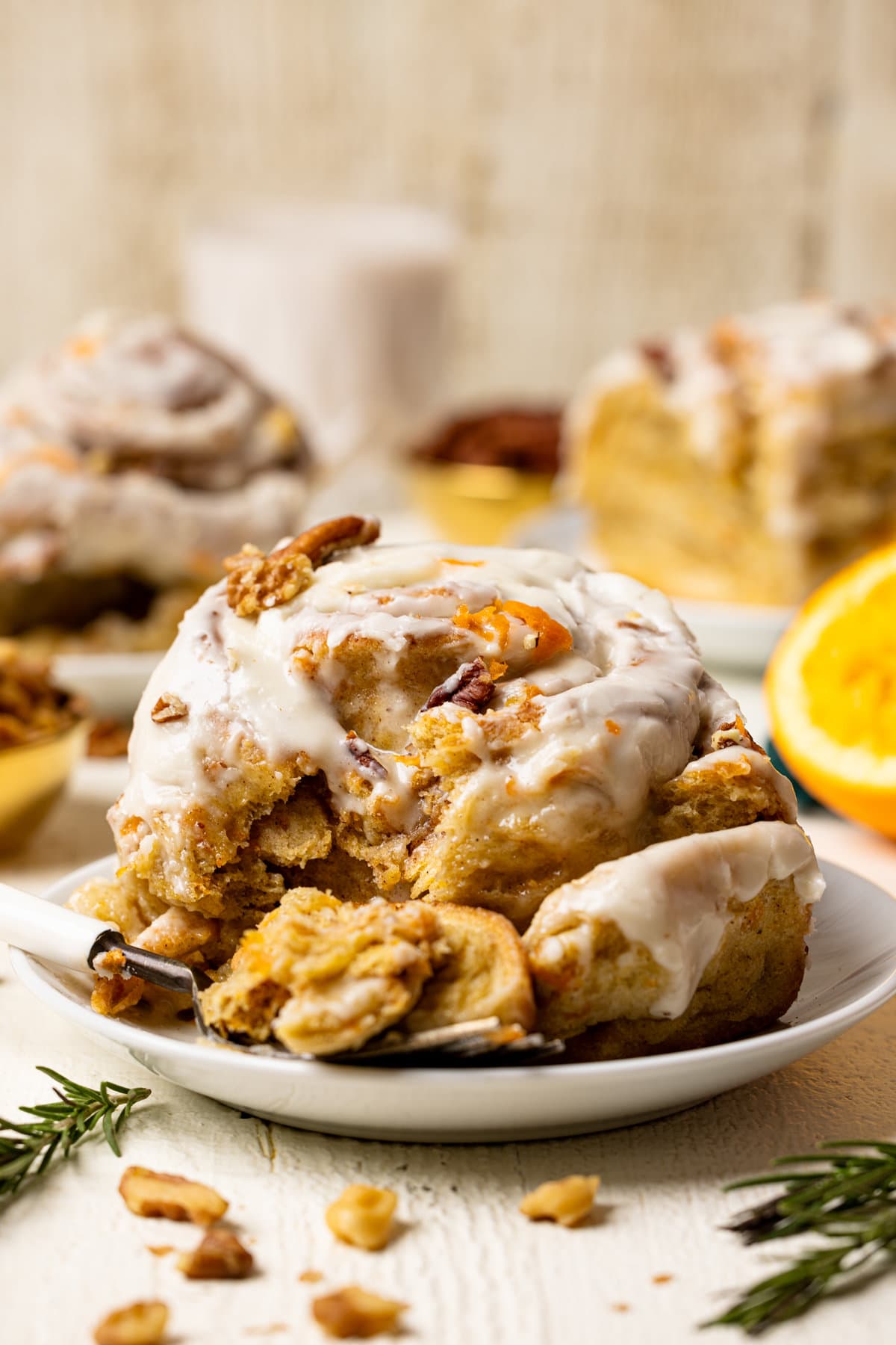 Southern-Style Carrot Cake Cinnamon Roll on a plate with a fork