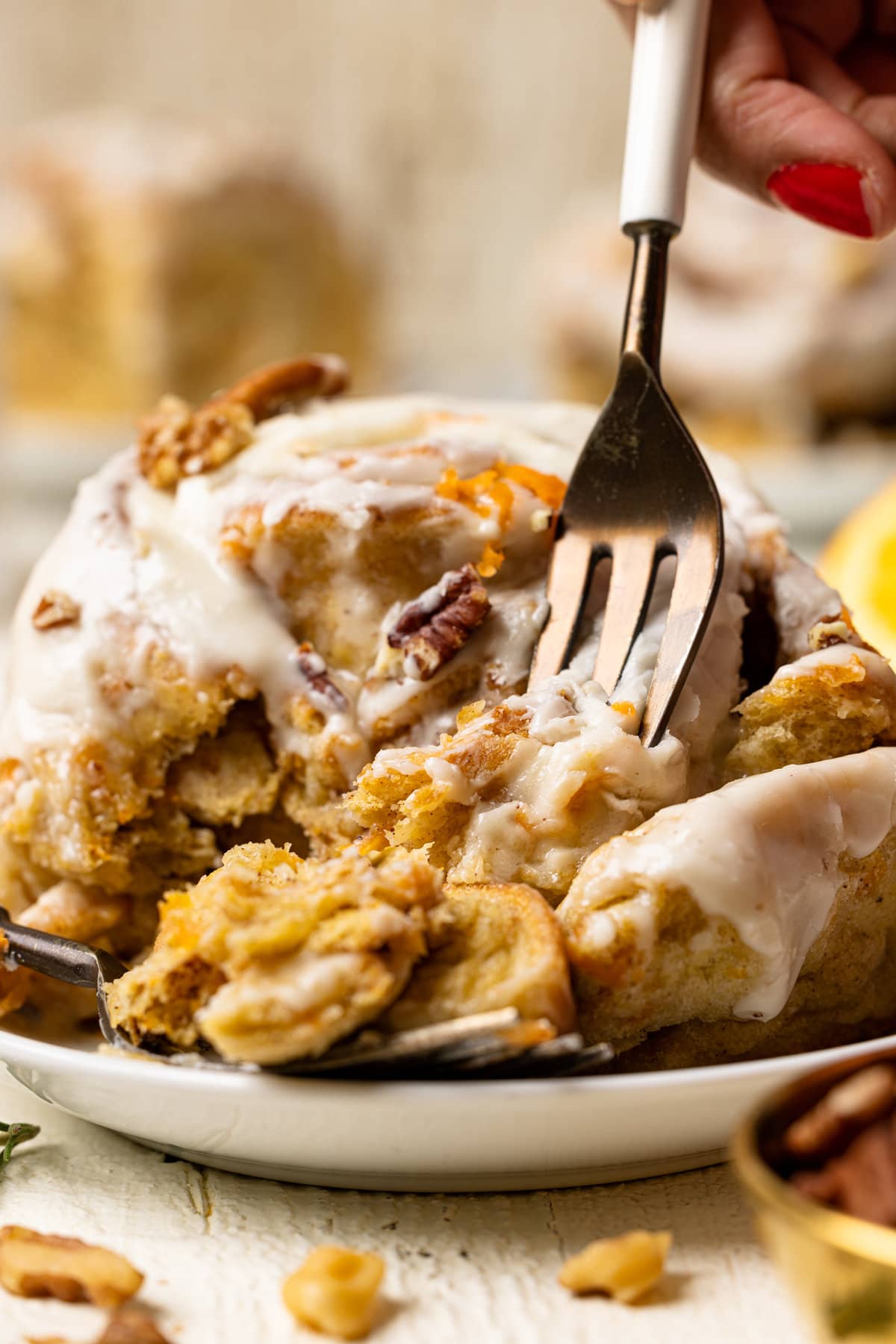 Fork grabbing a piece of a Southern-Style Carrot Cake Cinnamon Roll