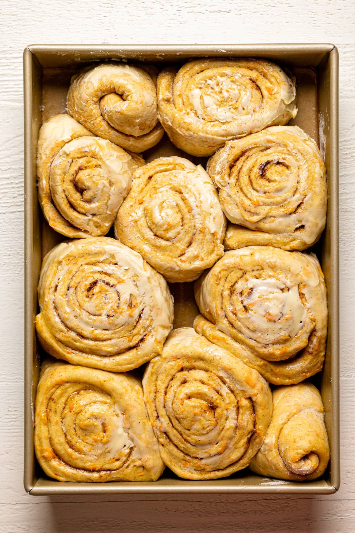 Uncooked Southern-Style Carrot Cake Cinnamon Rolls in a pan