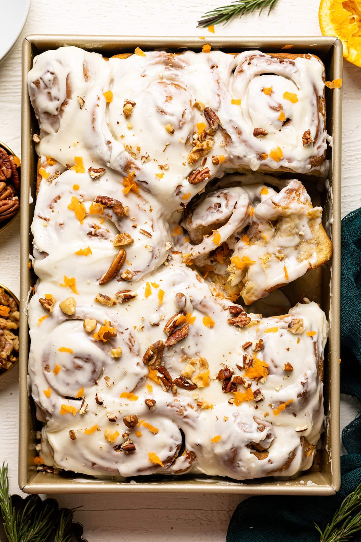 Pan of Southern-Style Carrot Cake Cinnamon Rolls with a roll missing