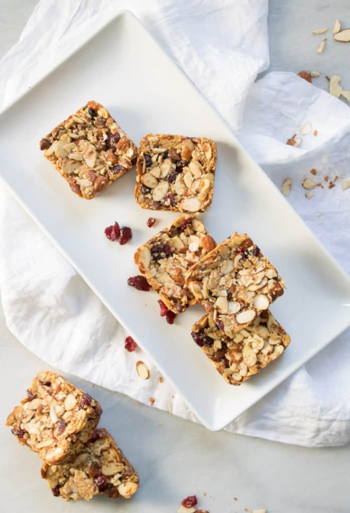 Chocolate Cranberry Almond Snack Bars on a white, rectangular plate.