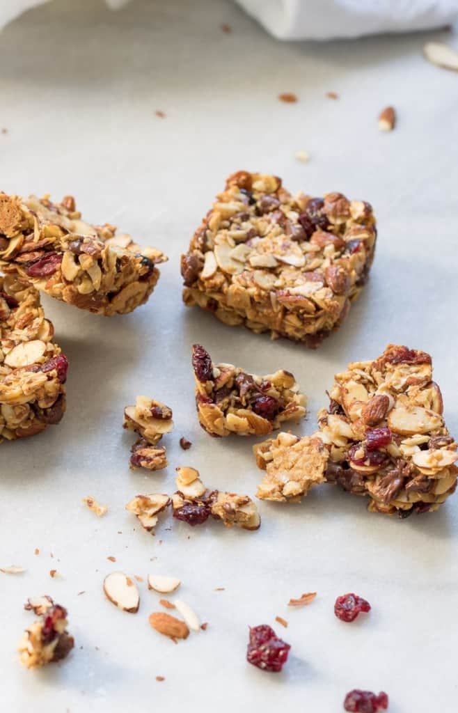 Chocolate Cranberry Almond Snack Bars on a countertop with snack bar crumbles.