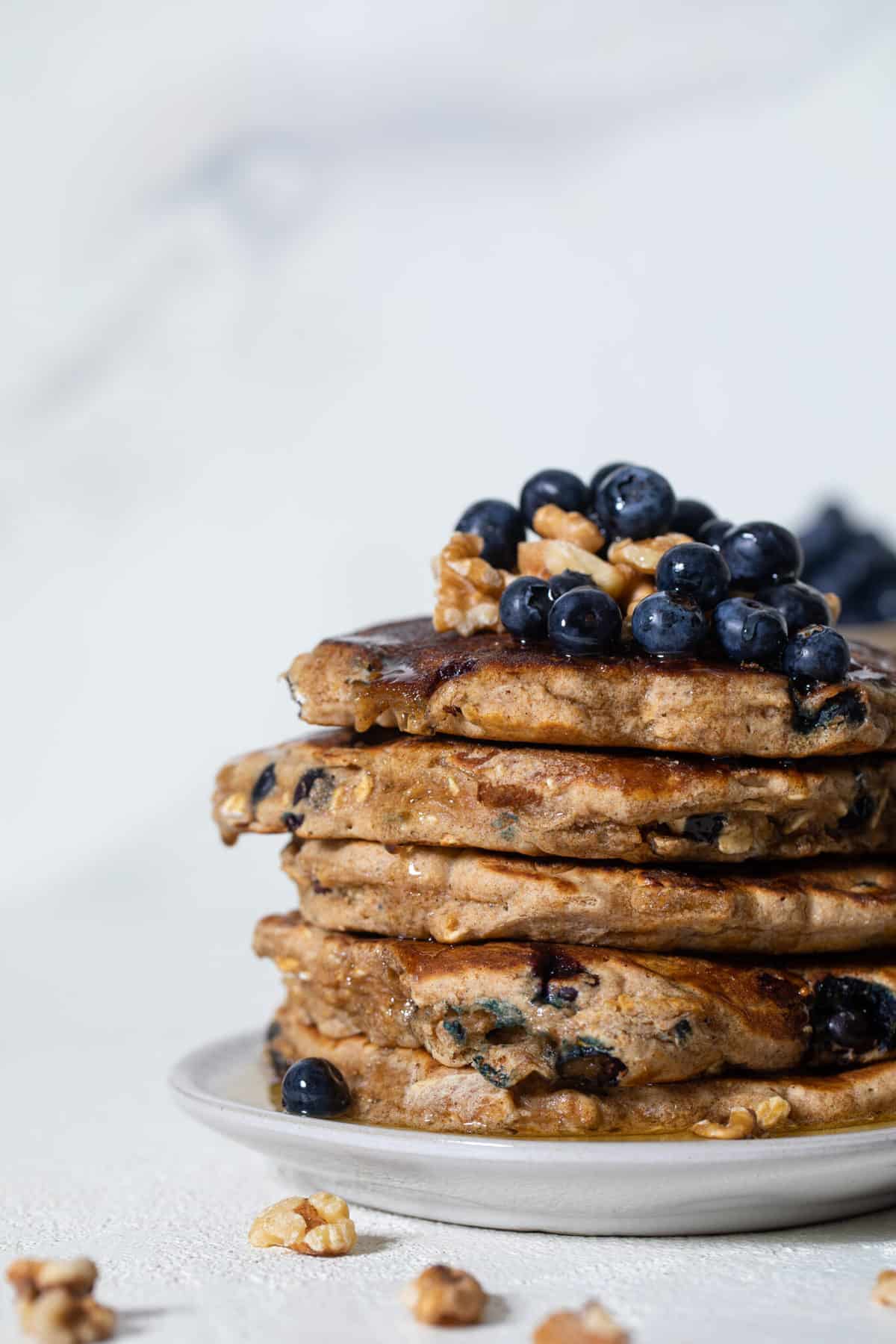 Stack of Blueberry Whole Wheat Pancakes topped with blueberries.