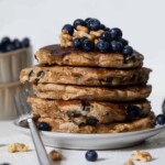 Blueberry Whole Wheat Pancakes on a plate with a fork.