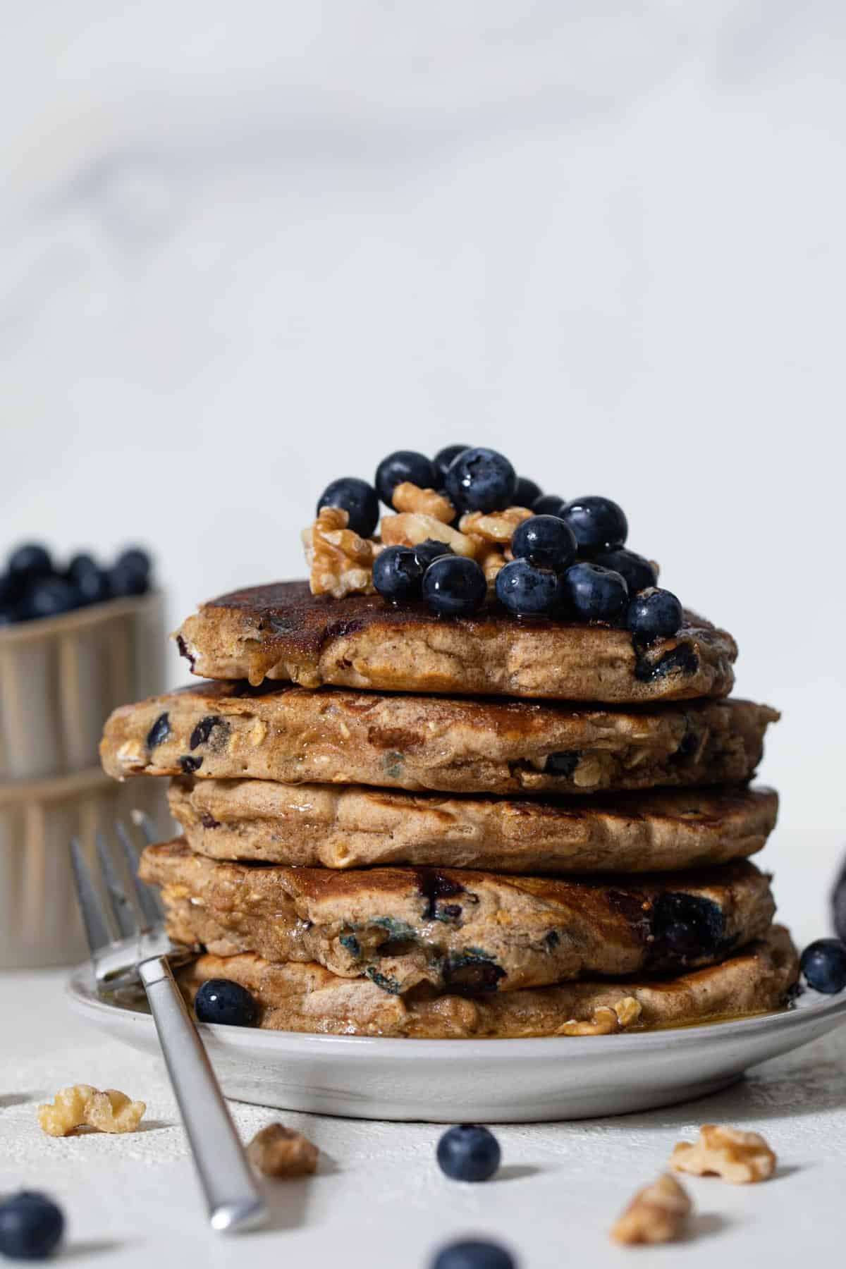 Blueberry Whole Wheat Pancakes on a plate with a fork.