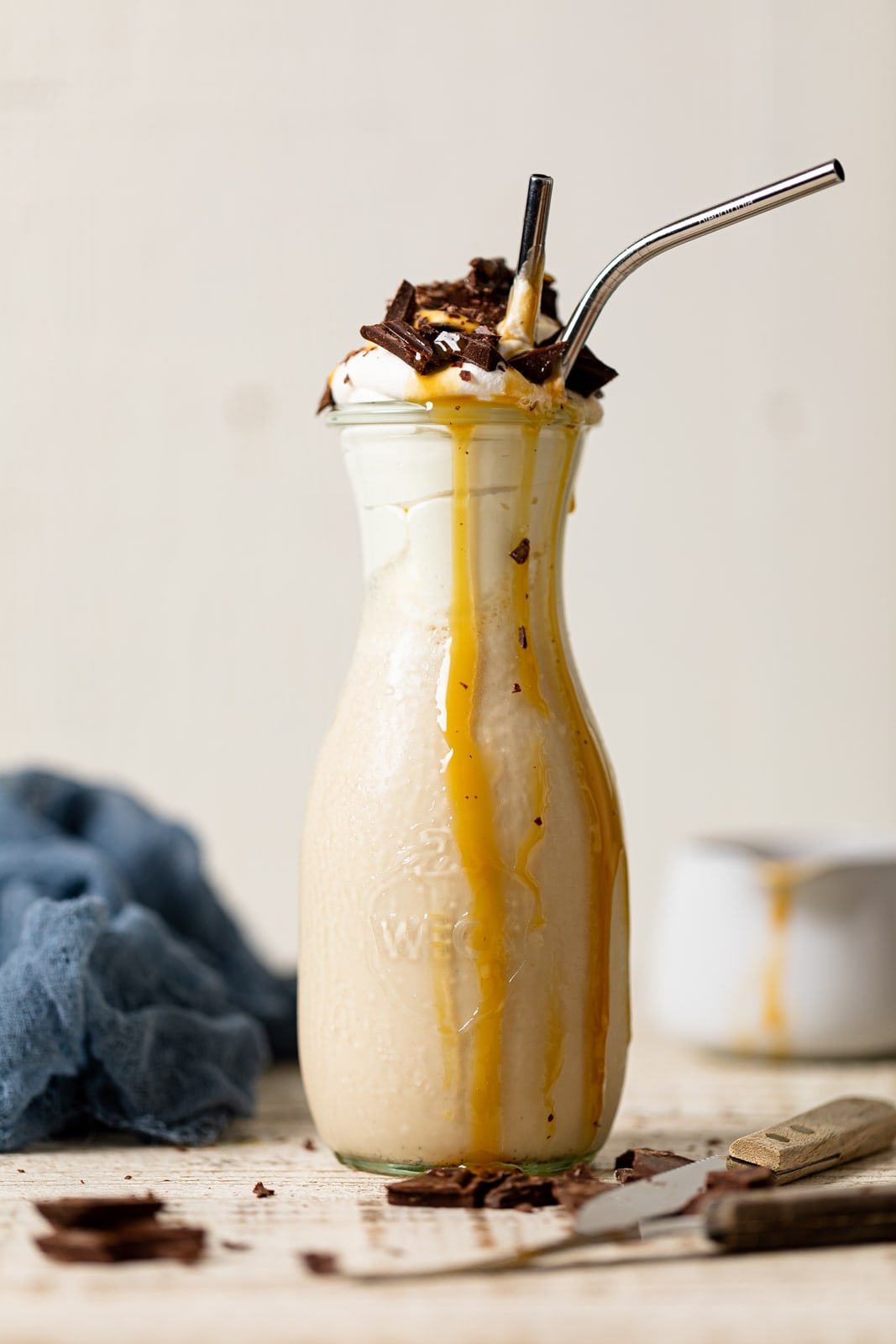 Salted Caramel Chunky Milkshake topped with chocolate with caramel dripping down the side