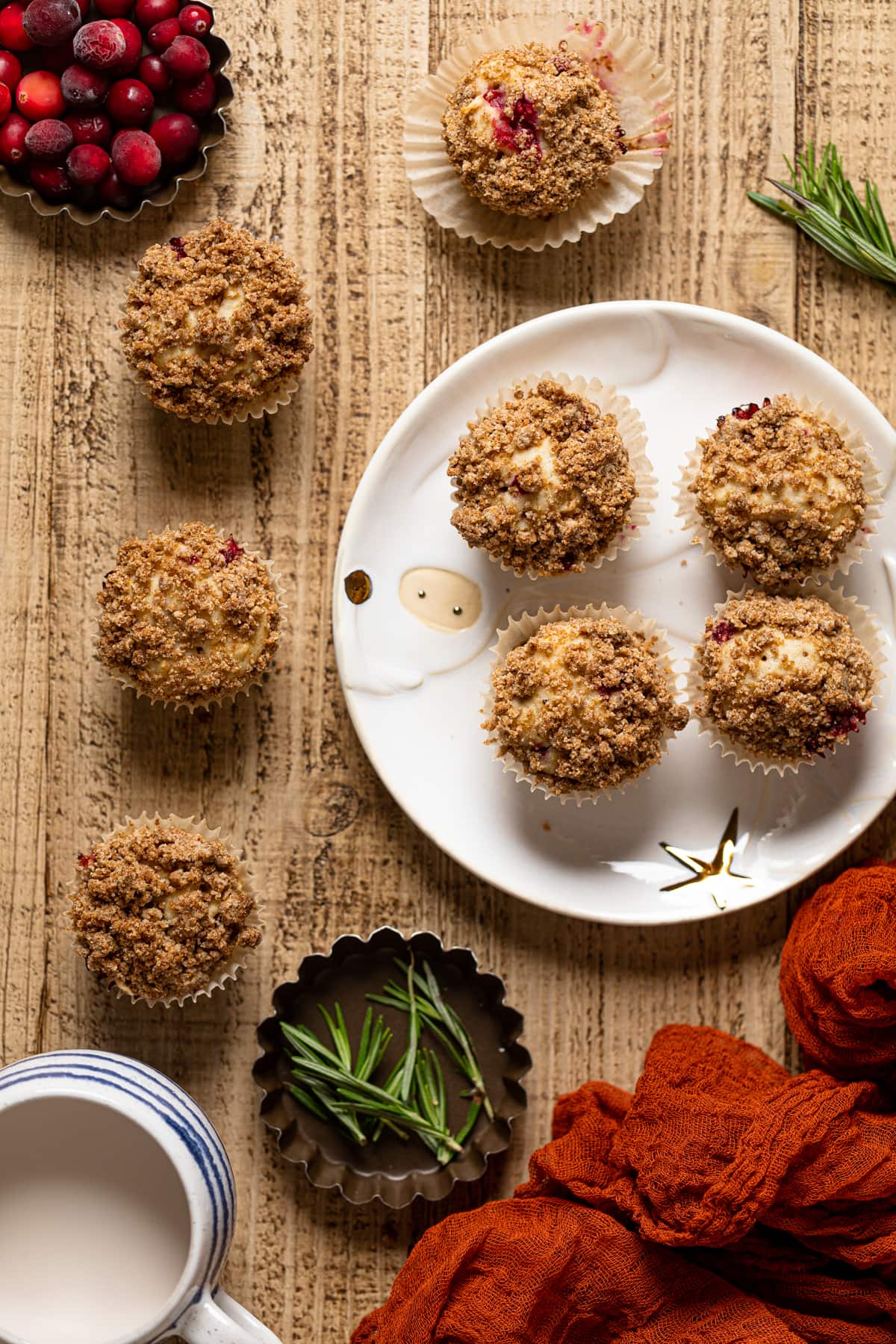 Vegan Orange Cranberry Breakfast Muffins on and next to a decorative plate