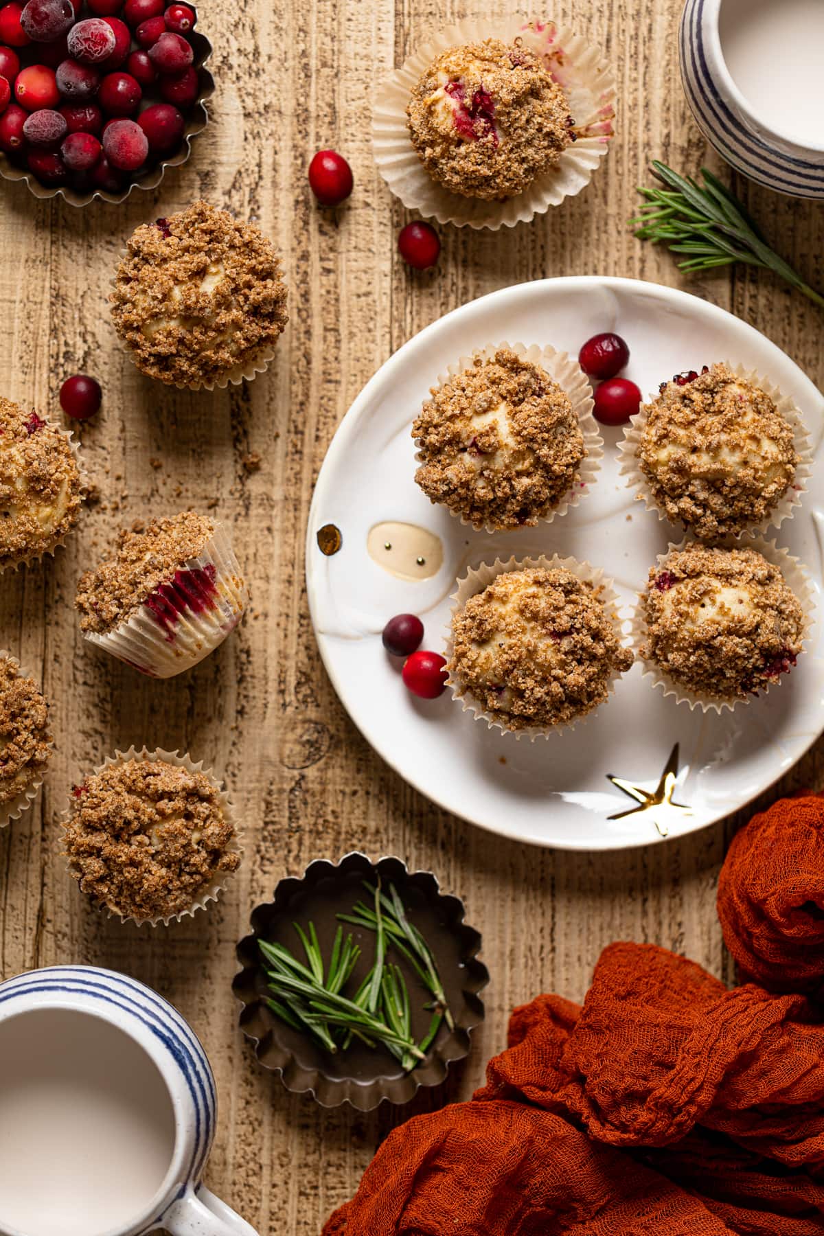 Vegan Orange Cranberry Breakfast Muffins on and next to a decorative plate