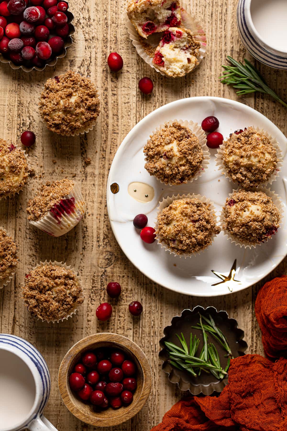 Overhead shot of Vegan Orange Cranberry Breakfast Muffins on and next to a decorative plate