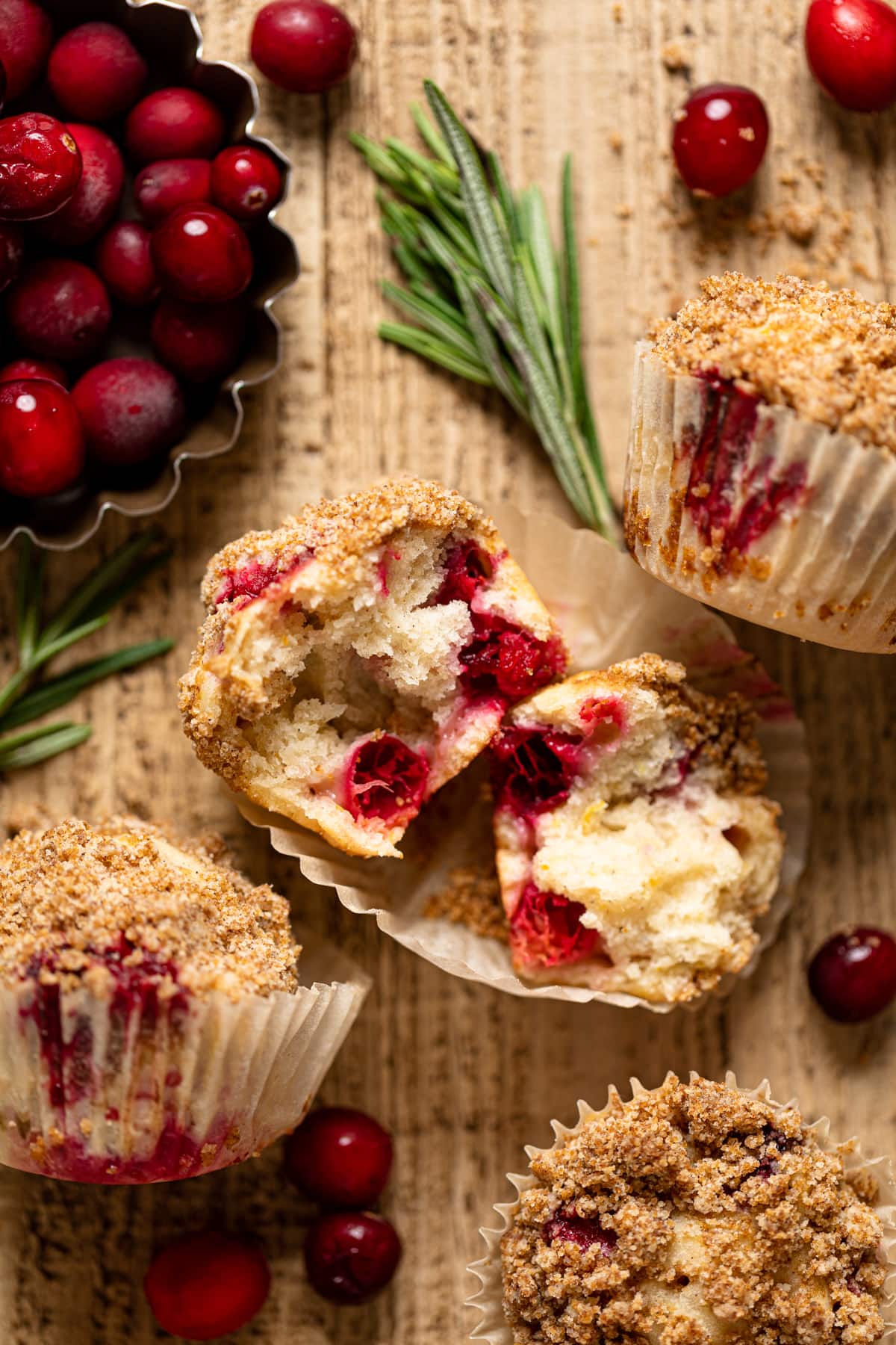 Vegan Orange Cranberry Breakfast Muffin split open on a muffin liner